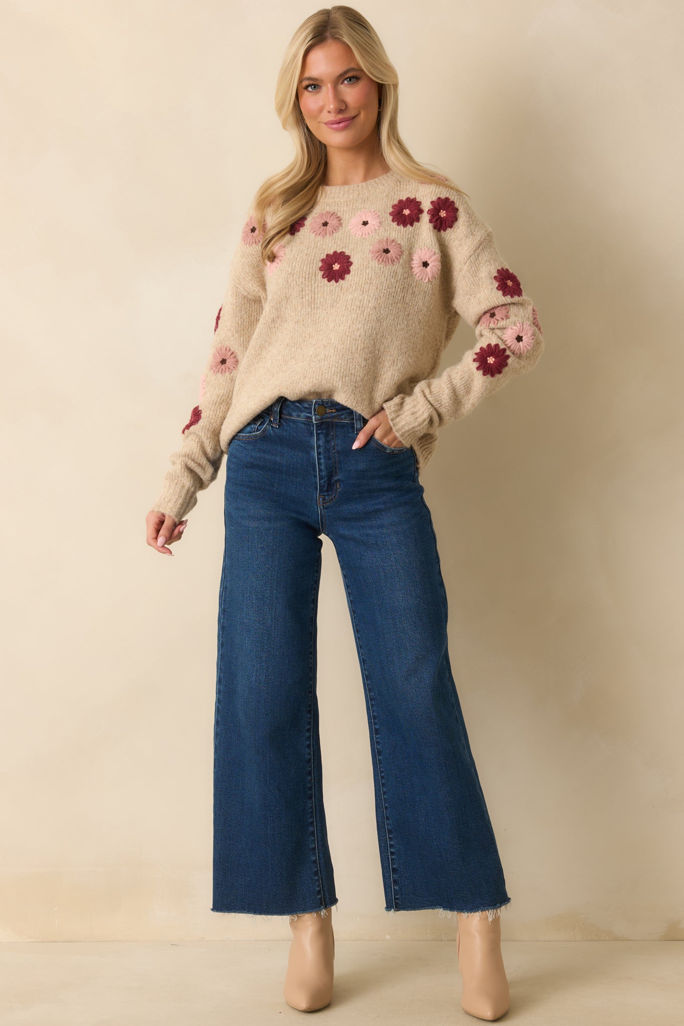 Oatmeal sweater with crew neckline and long sleeves, featuring textured floral embroidery in blush, rose, and wine tones.