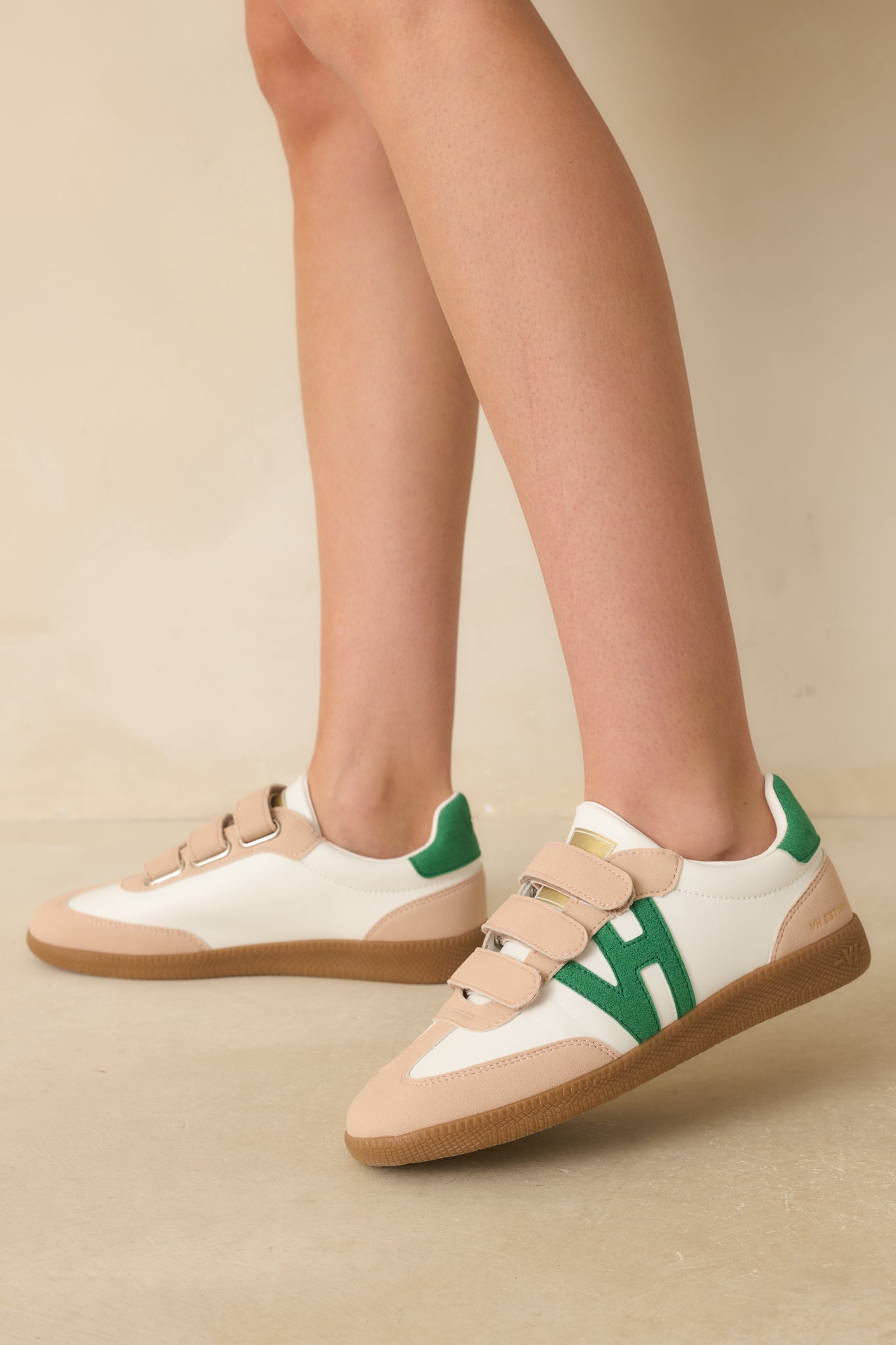 Side-angle photo highlighting the green faux suede side logo appliqué and matching heel tab.
