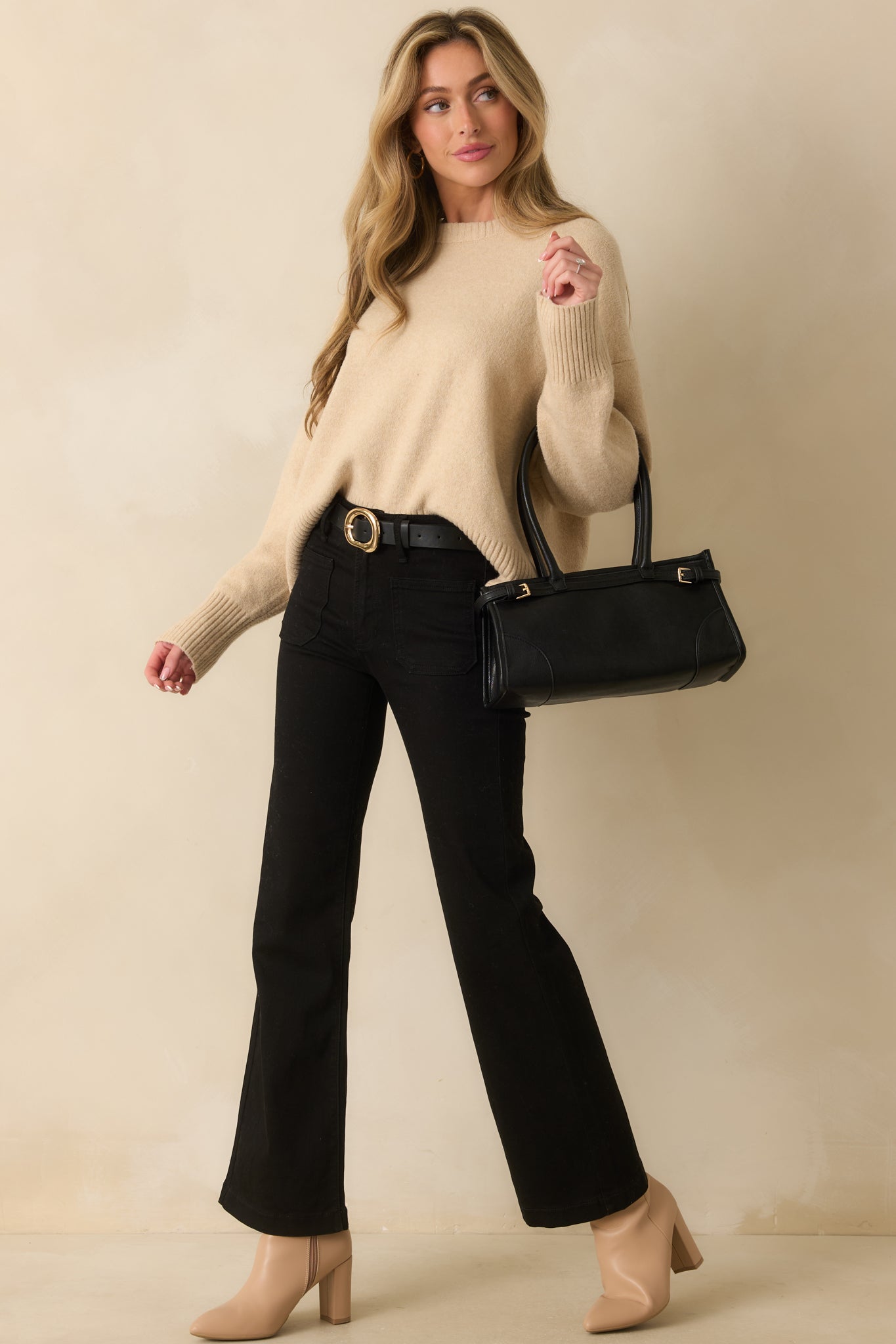 Full body front view of natural beige sweater with crew neckline, long sleeves, and ribbed hems.