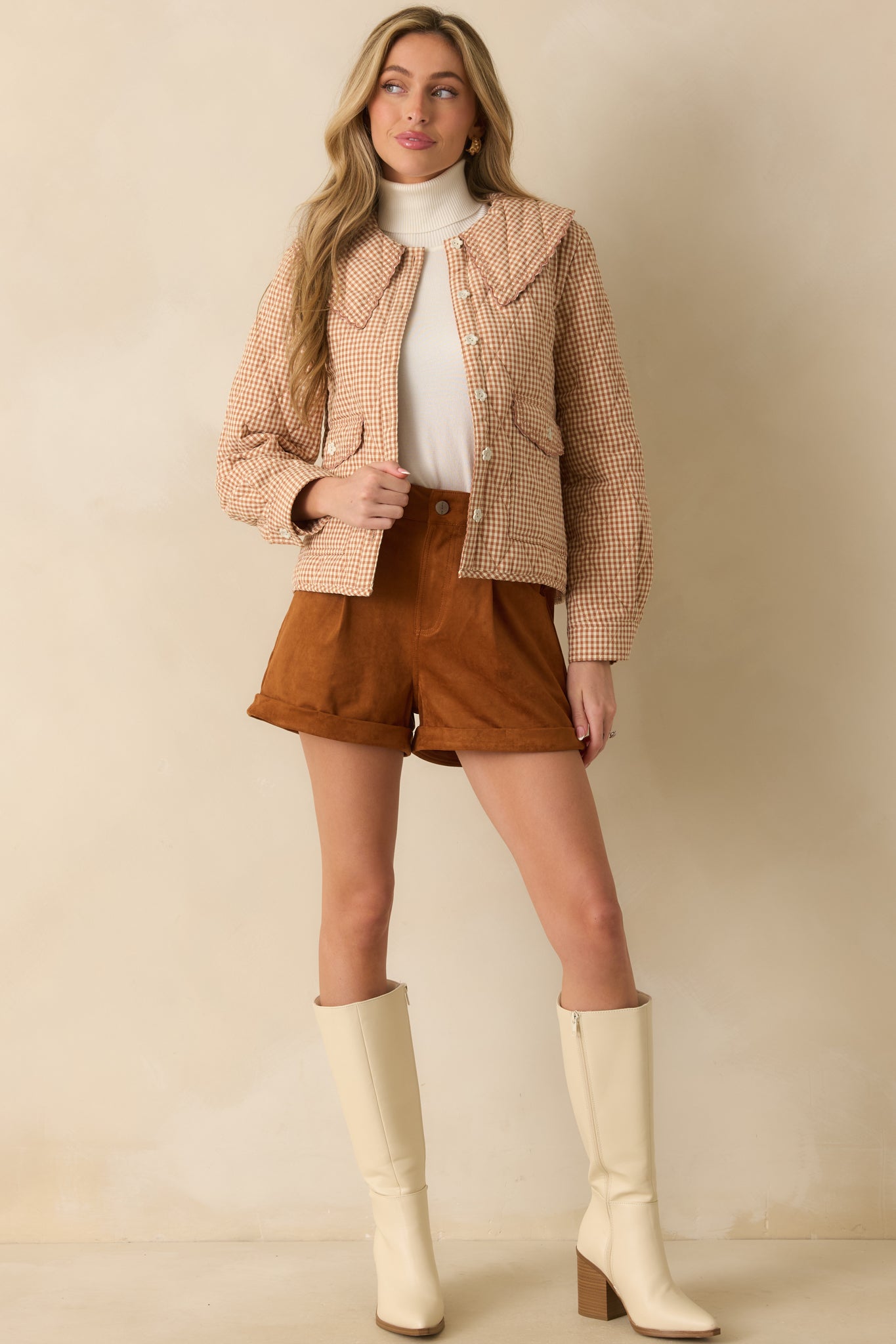 Full body front view of a light rust gingham jacket with quilted diamond stitching, oversized scalloped collar, and button front closure.