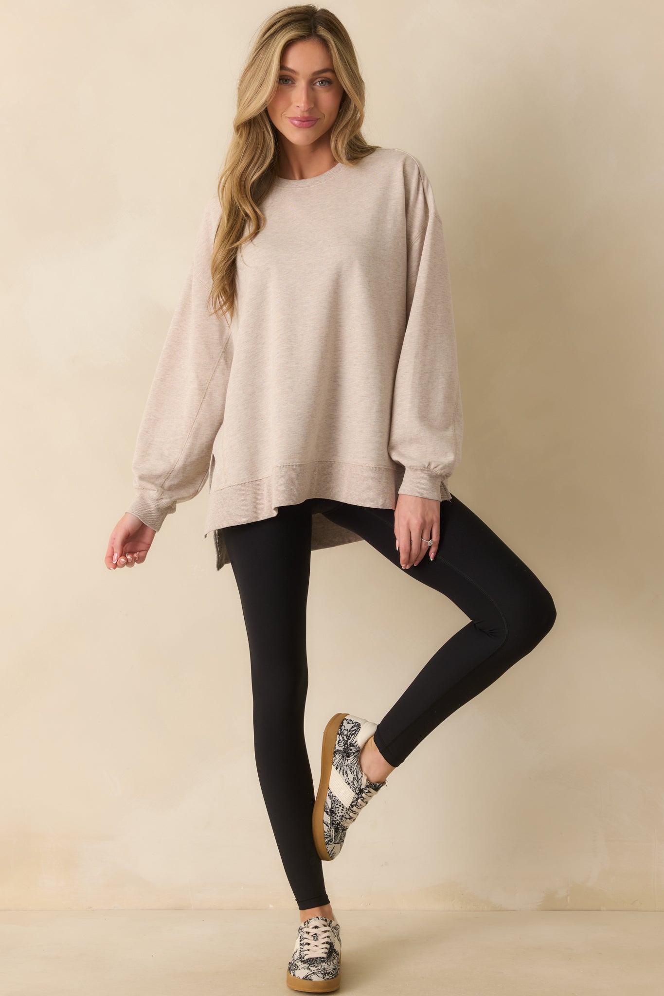 Natural heather sweatshirt with a relaxed fit, crew neckline, and long sleeves, highlighting its soft cotton-blend fabric.