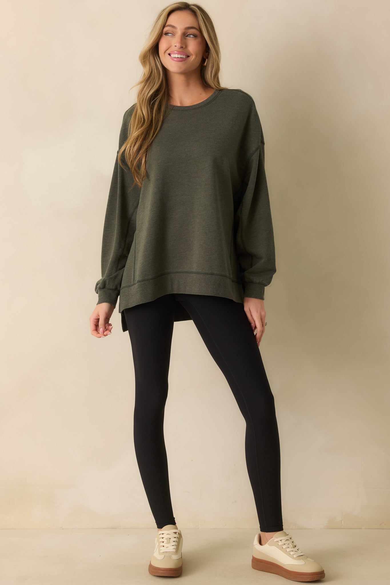 Full body front angle highlighting the long sleeves and ribbed cuffs of the sweatshirt.