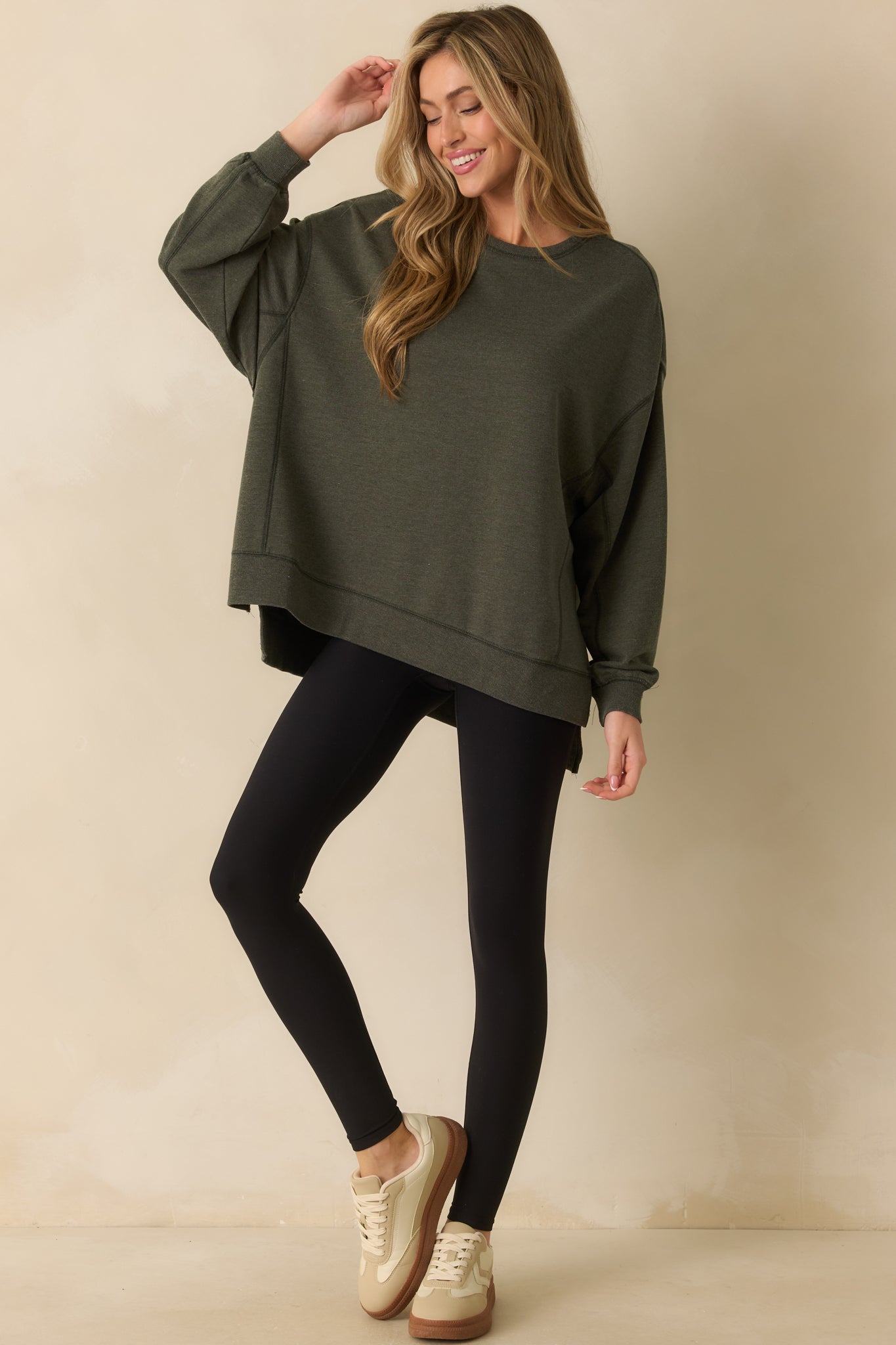 Full body front view of the sage green sweatshirt featuring a relaxed fit and classic crew neckline.