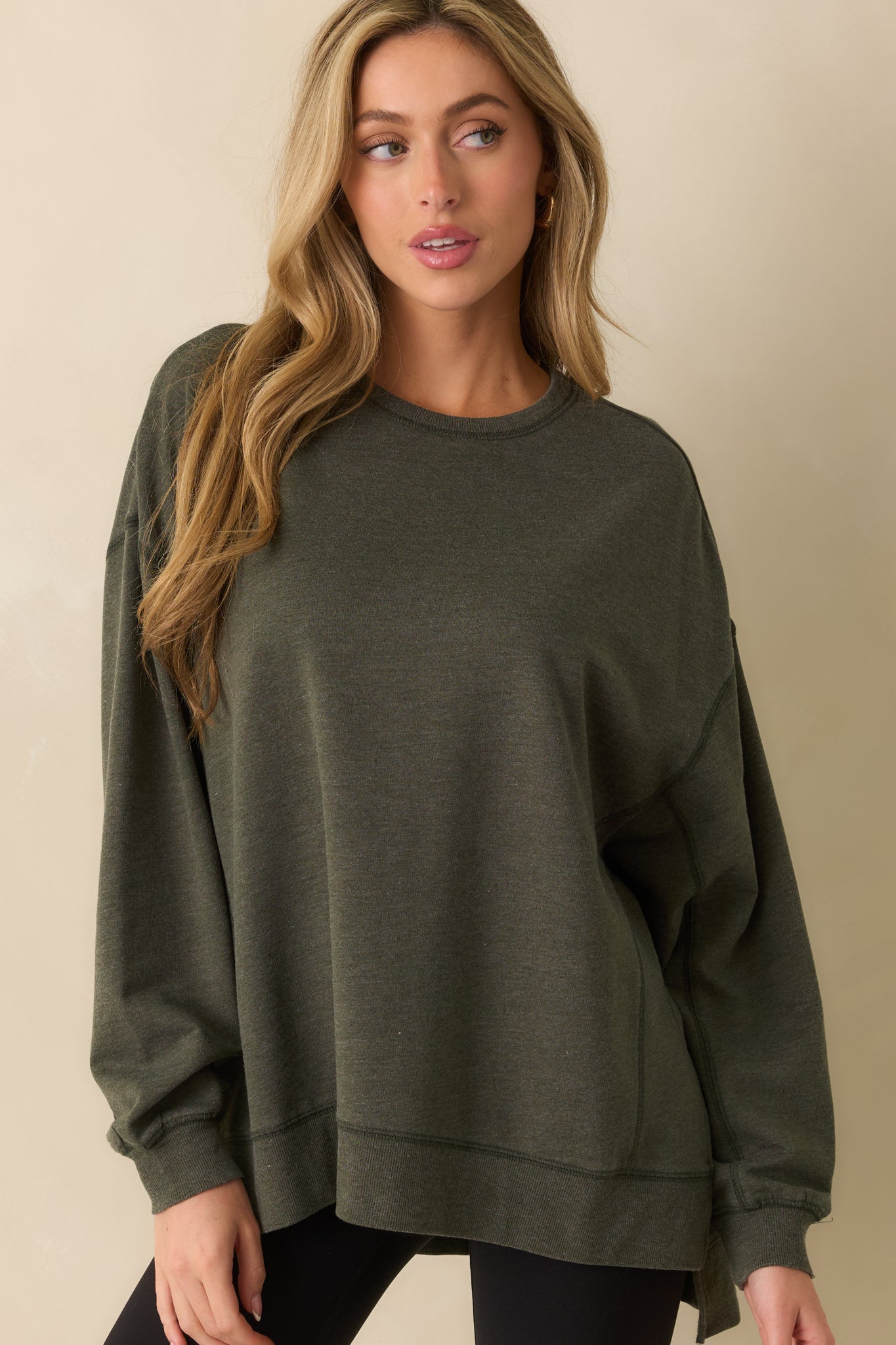 Cropped front view focusing on the crew neckline and smooth sage green fabric texture.