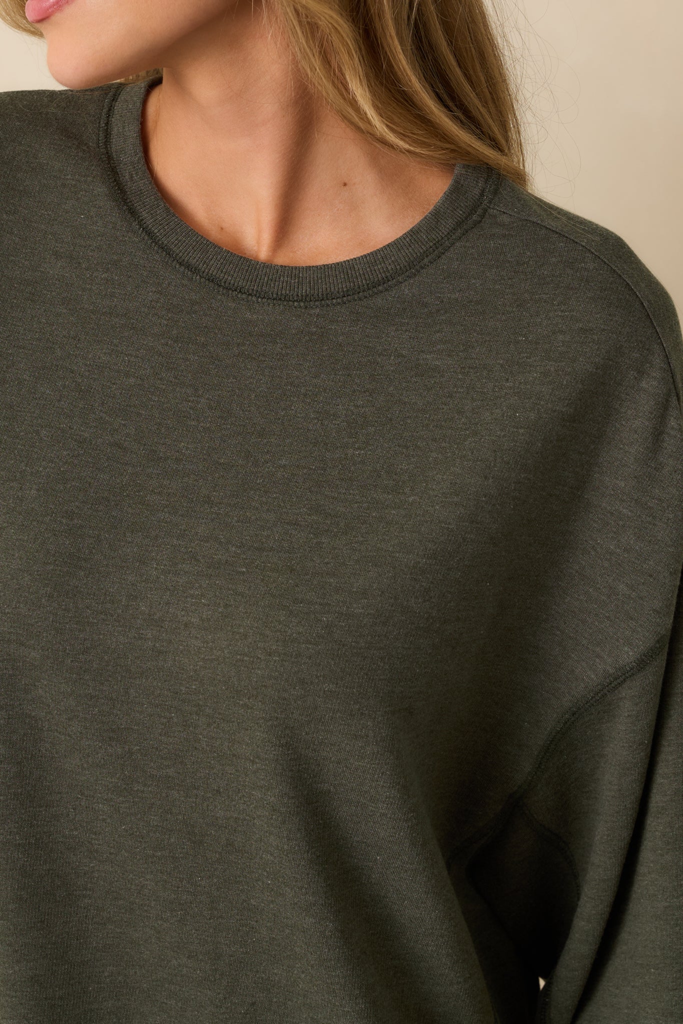 Close-up detail shot of the sweatshirt’s ribbed trim and fine cotton-blend fabric texture.