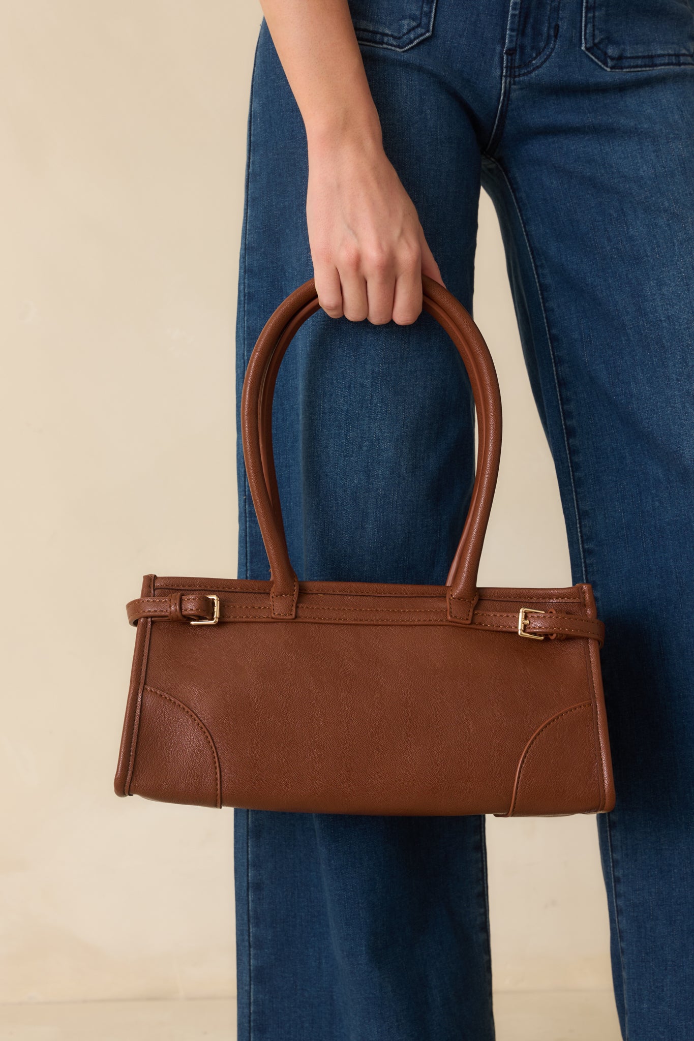 Closer look at the belted side design and structured silhouette that define the handbag’s modern elegance.