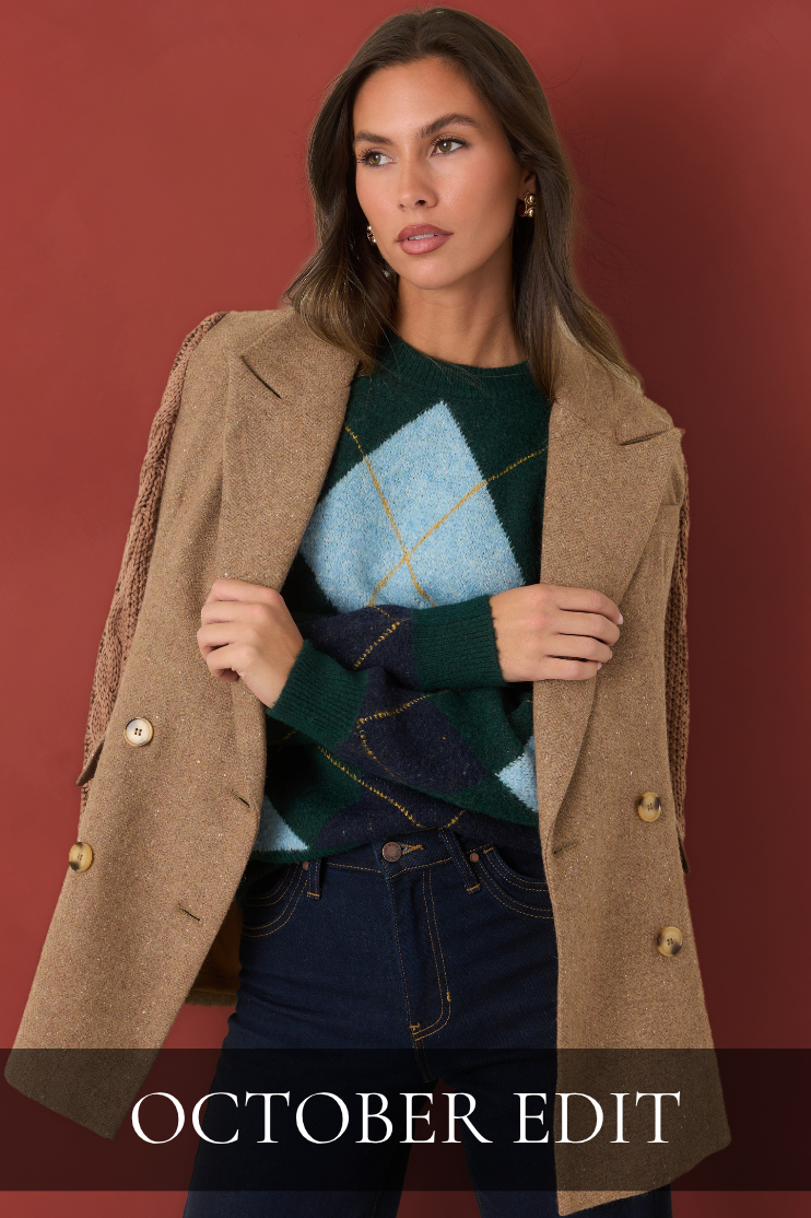 Model wearing a tan blazer over a green and blue argyle sweater with dark jeans against a red background. Text reads ‘October Edit.’
