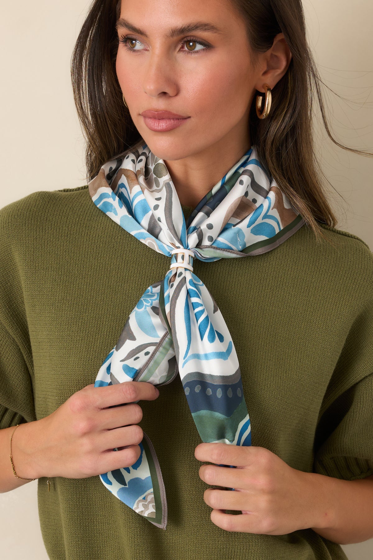 Square satin scarf showcasing olive green, blue, ivory, camel, and brown ornamental medallions.