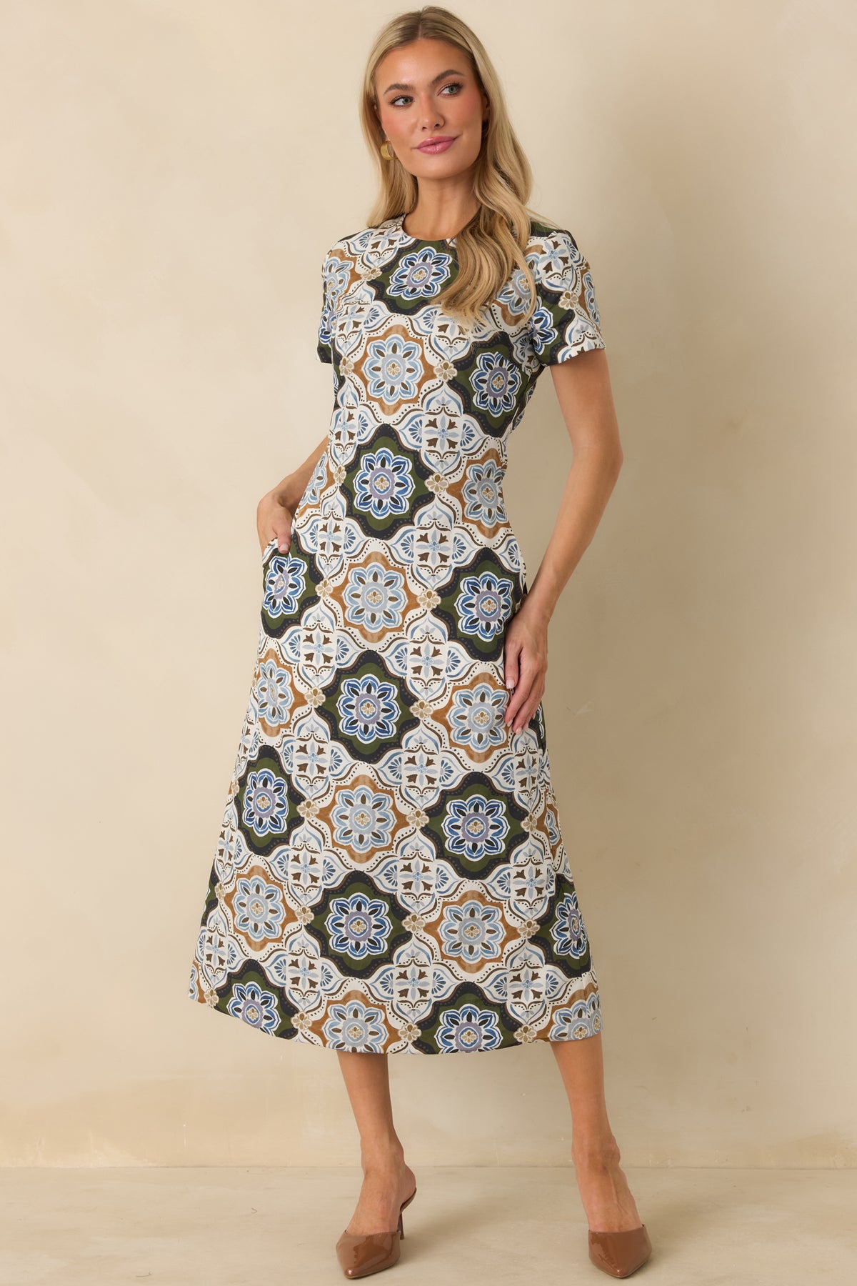 Olive and blue medallion print dress with ivory and camel accents, a polished A-line silhouette, and short sleeves.