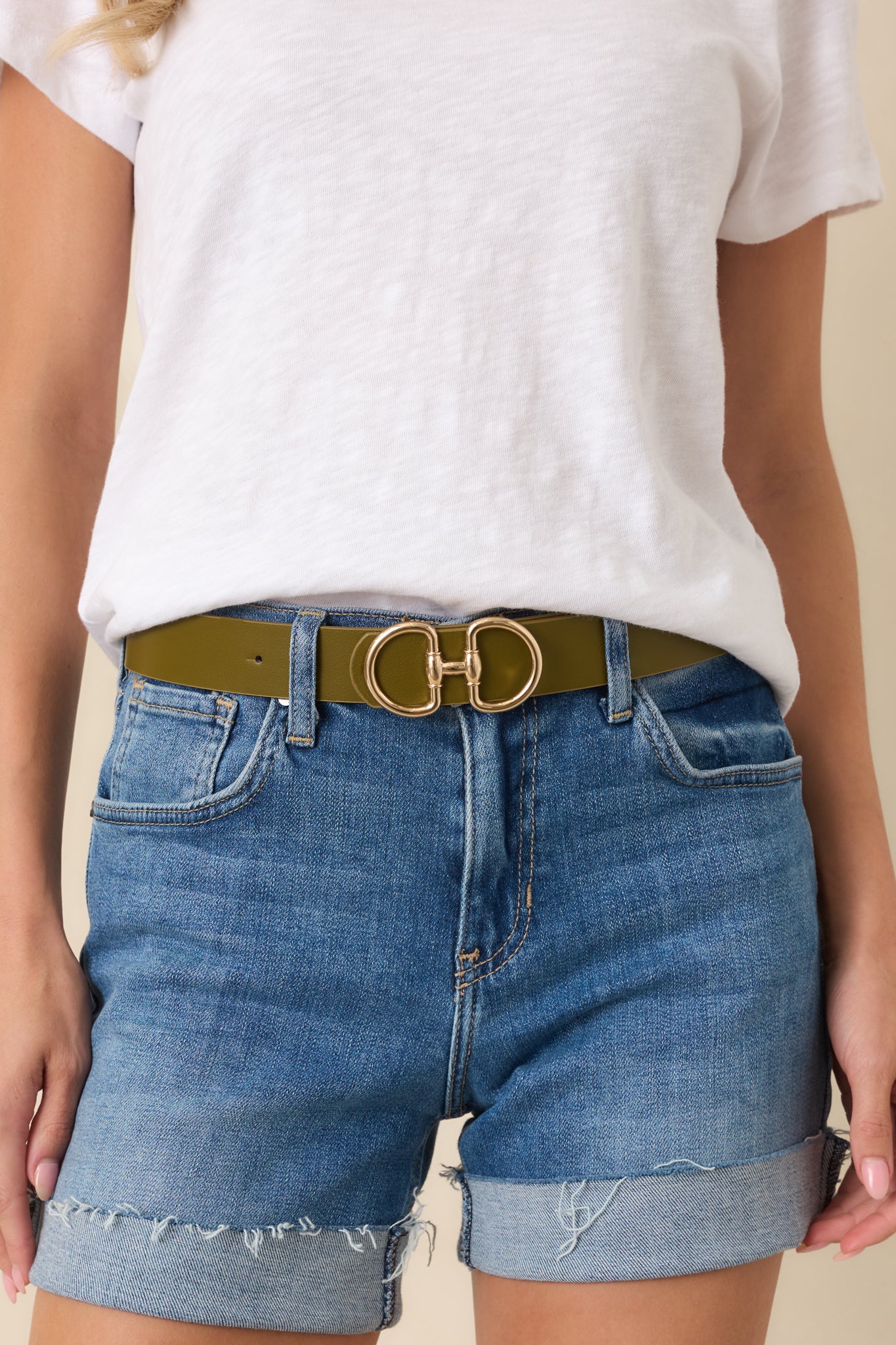 Olive faux leather belt featuring a smooth strap and statement gold-tone double ring buckle.