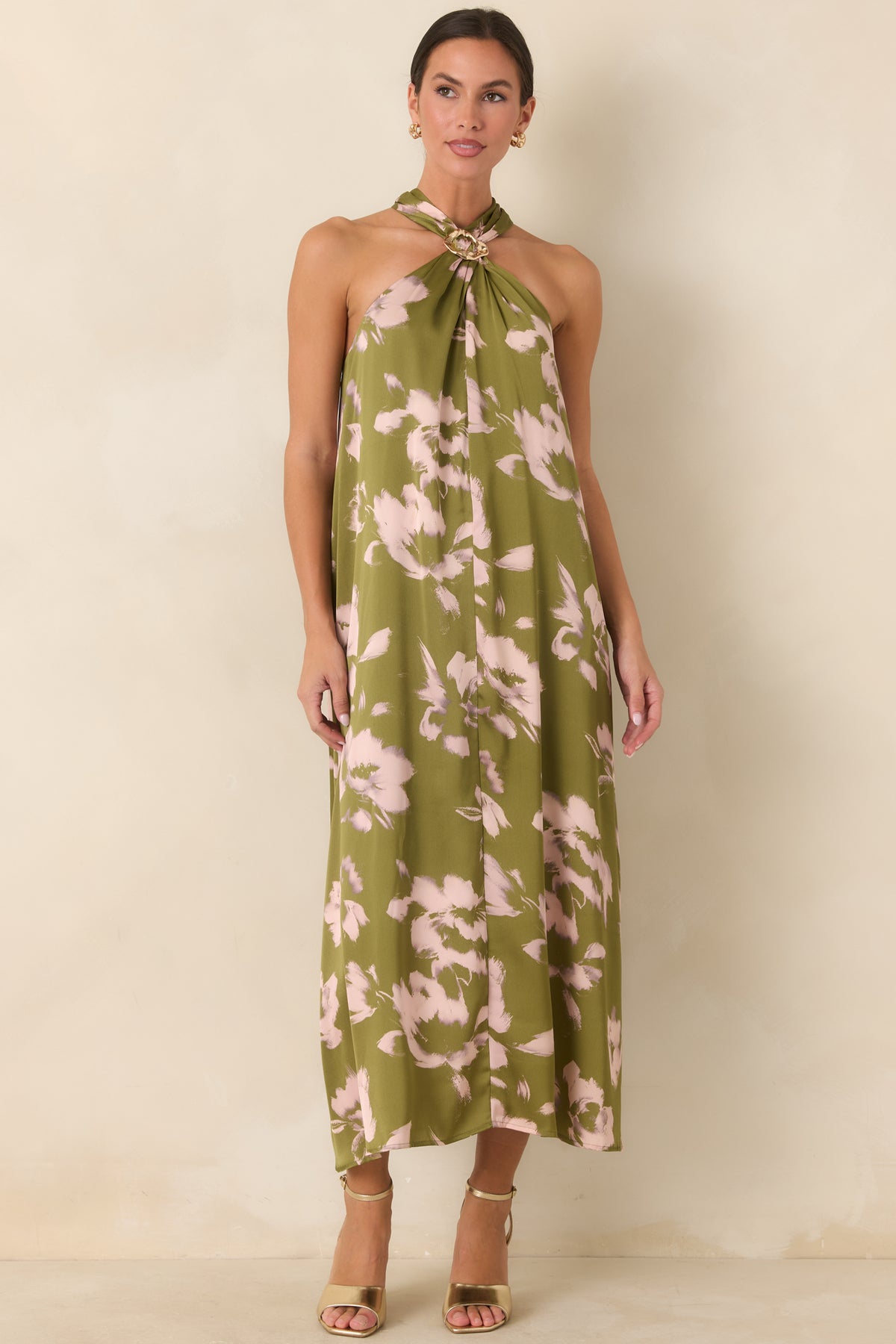 Olive floral maxi dress with soft neckline folds creating a relaxed silhouette without a defined waist.
