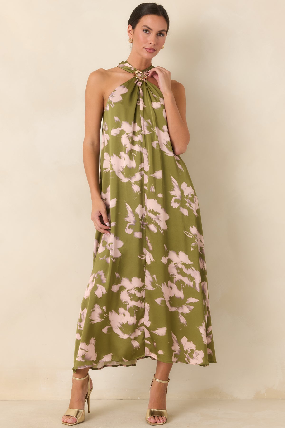 Olive floral maxi silhouette with a sculptural gold-tone neckline accent and softly flowing fabric throughout.