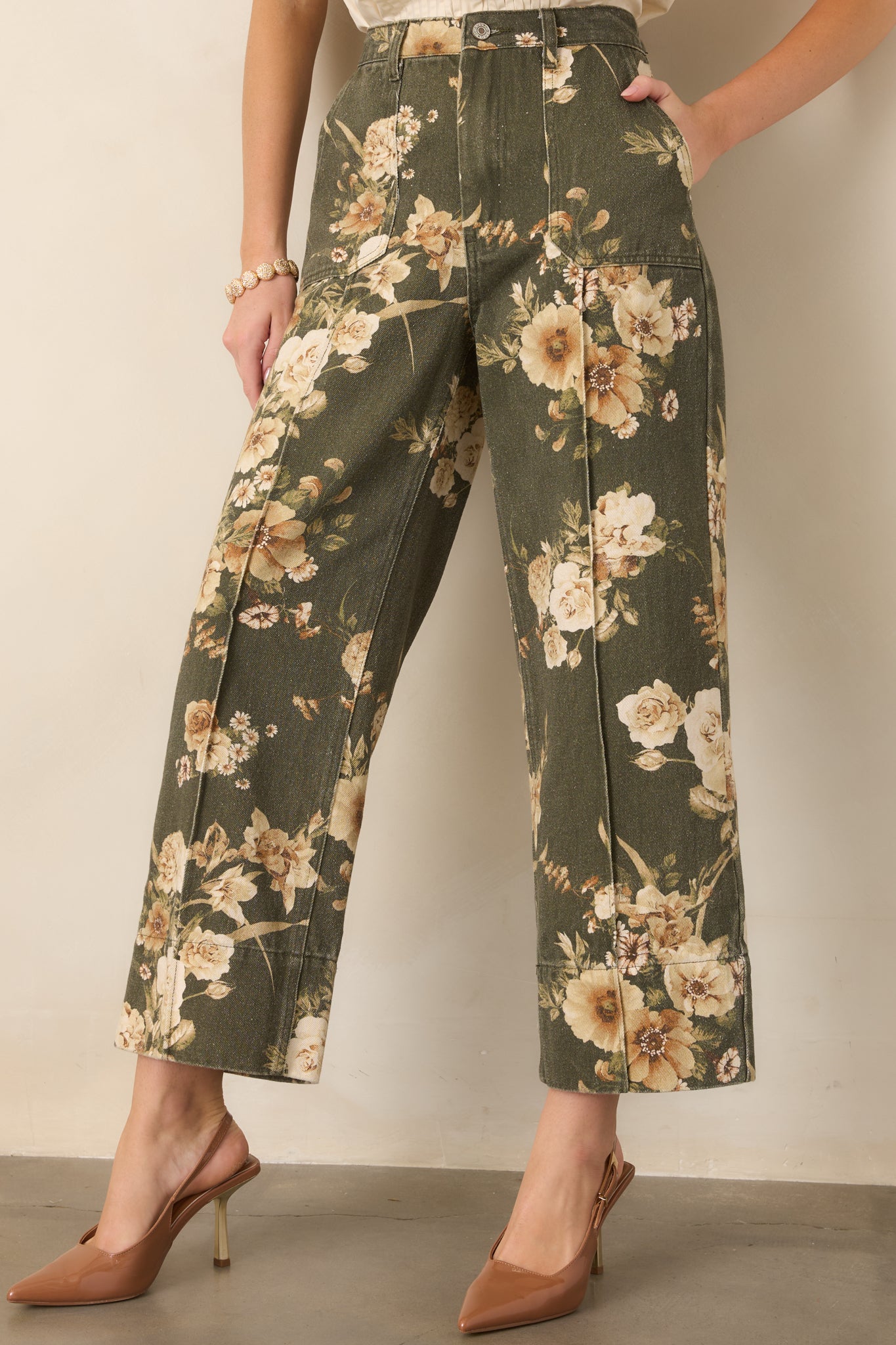 High-rise olive green waistband and ivory floral print highlight the structured cotton construction of these wide-leg pants.