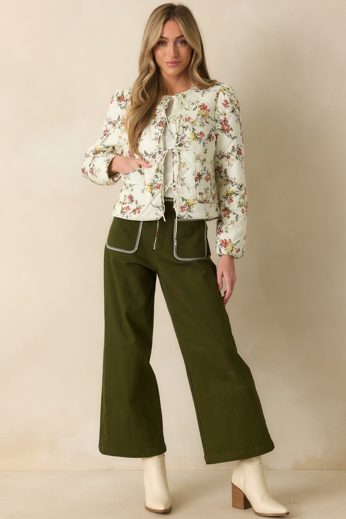 Olive green high-rise jeans with belt loops and classic button zipper closure.