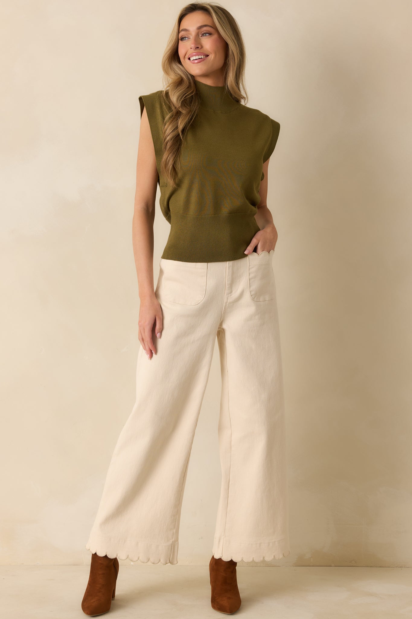 Olive green knit top with mock neckline, cap sleeves, and fitted waistband.