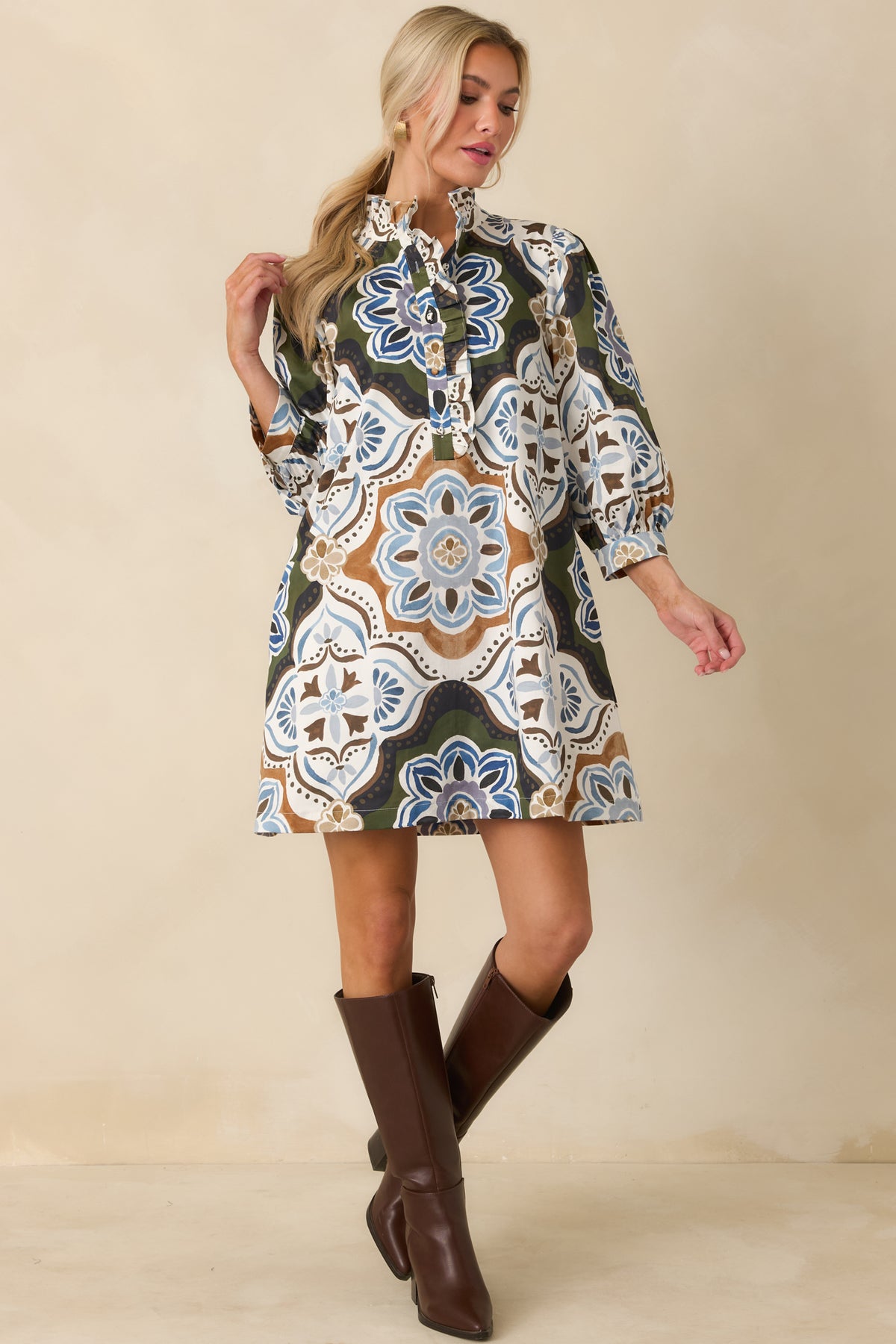 Olive green shift mini dress featuring an oversized medallion print in ivory, blue, camel, and rich brown.