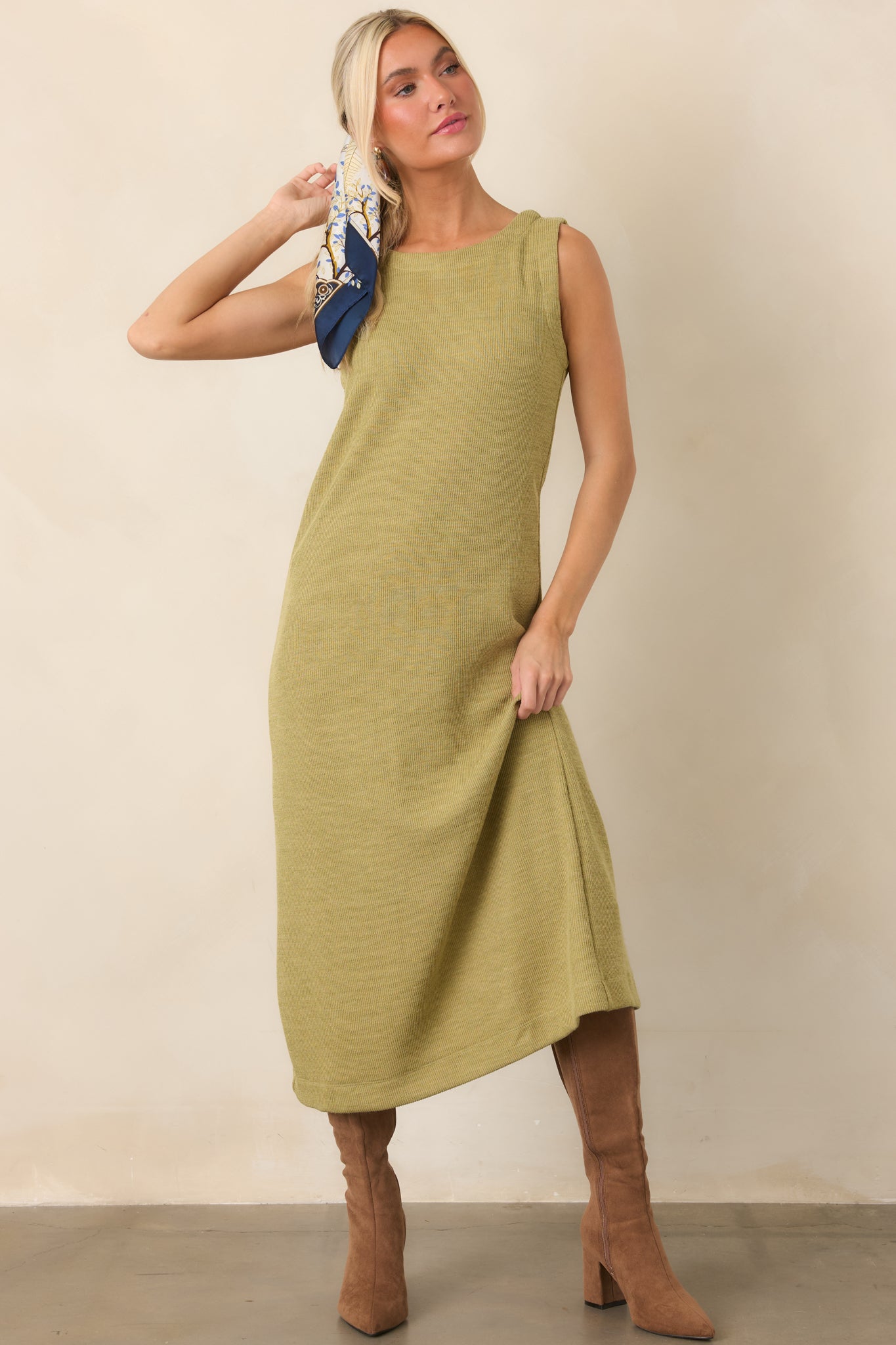 Streamlined rib knit dress in olive green with a simple sleeveless design and comfortable midi length.