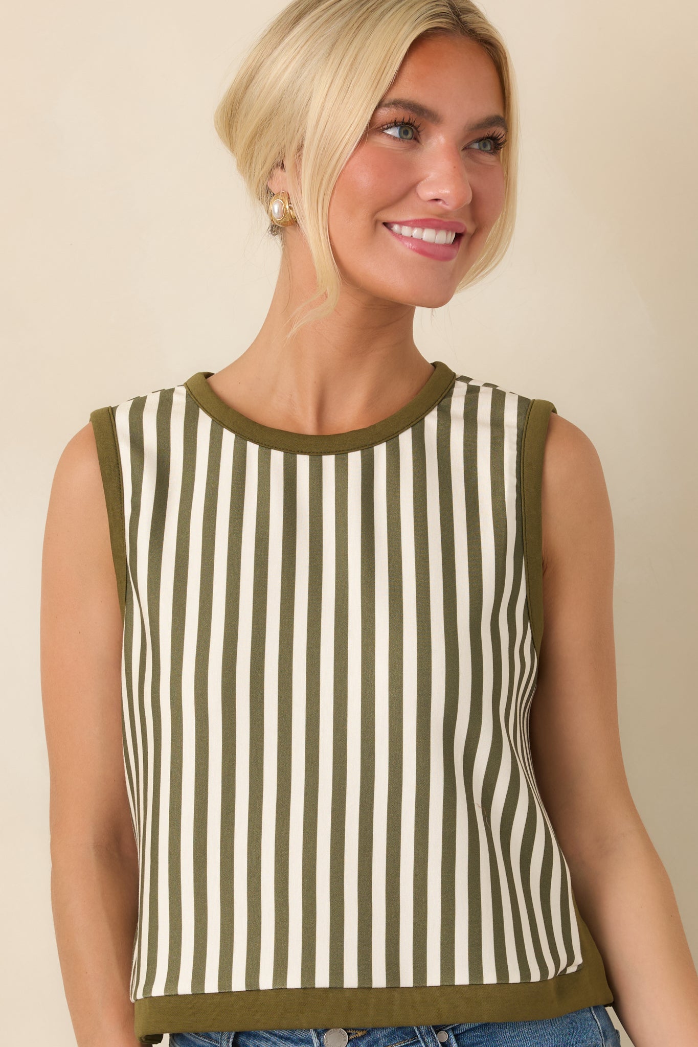 Close view of the relaxed cropped silhouette, showcasing the sleeveless construction and crisp olive and ivory stripe pattern.
