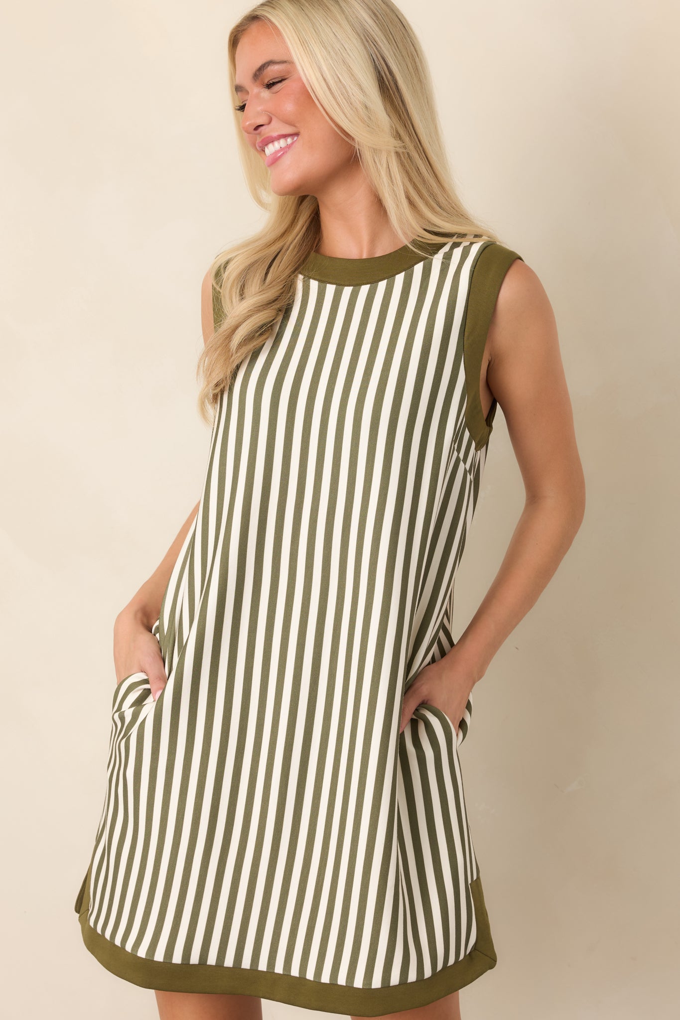 Olive and ivory striped dress featuring a practical side pocket and small side slit along the lower hem.