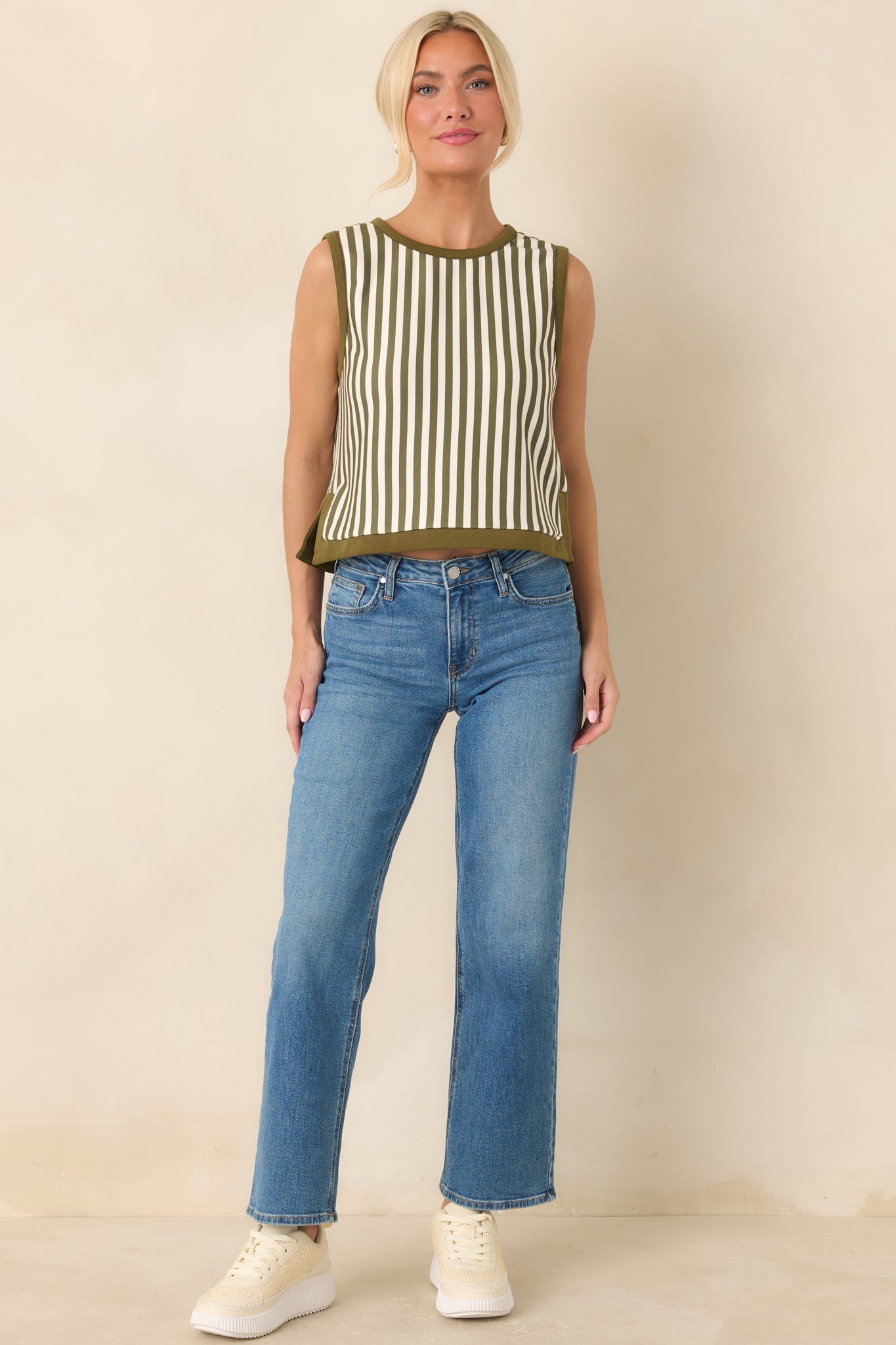 Olive and ivory striped sleeveless top showcasing a casual cropped shape, round neckline, and polished contrast trim.
