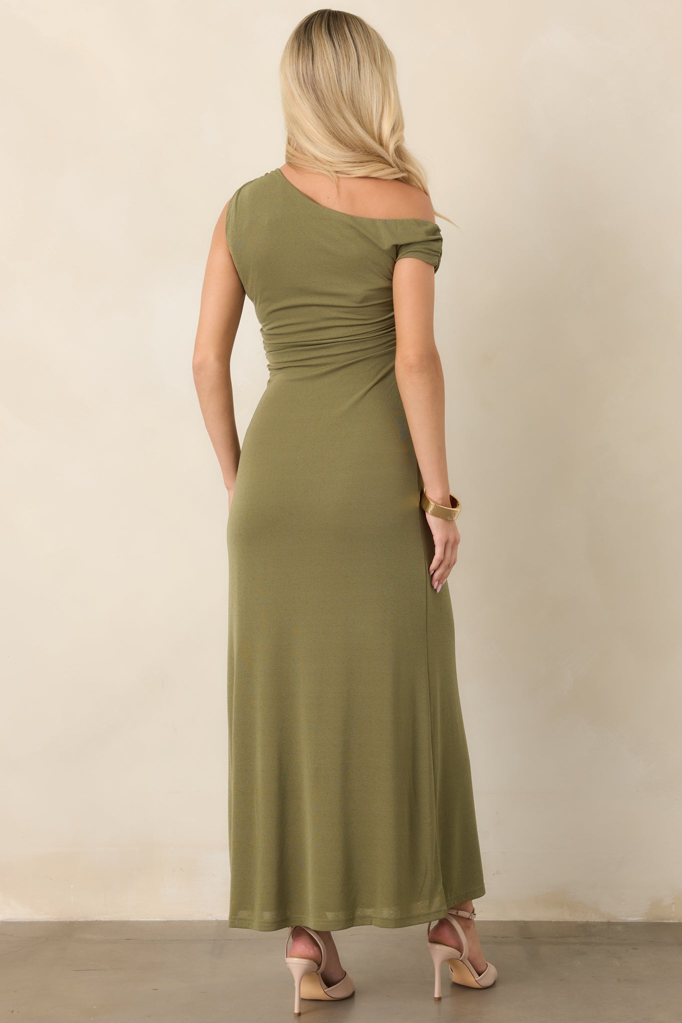 Rear view of the olive green mesh dress showcasing the fitted bodice, softly ruched waist, and long fluid skirt.
