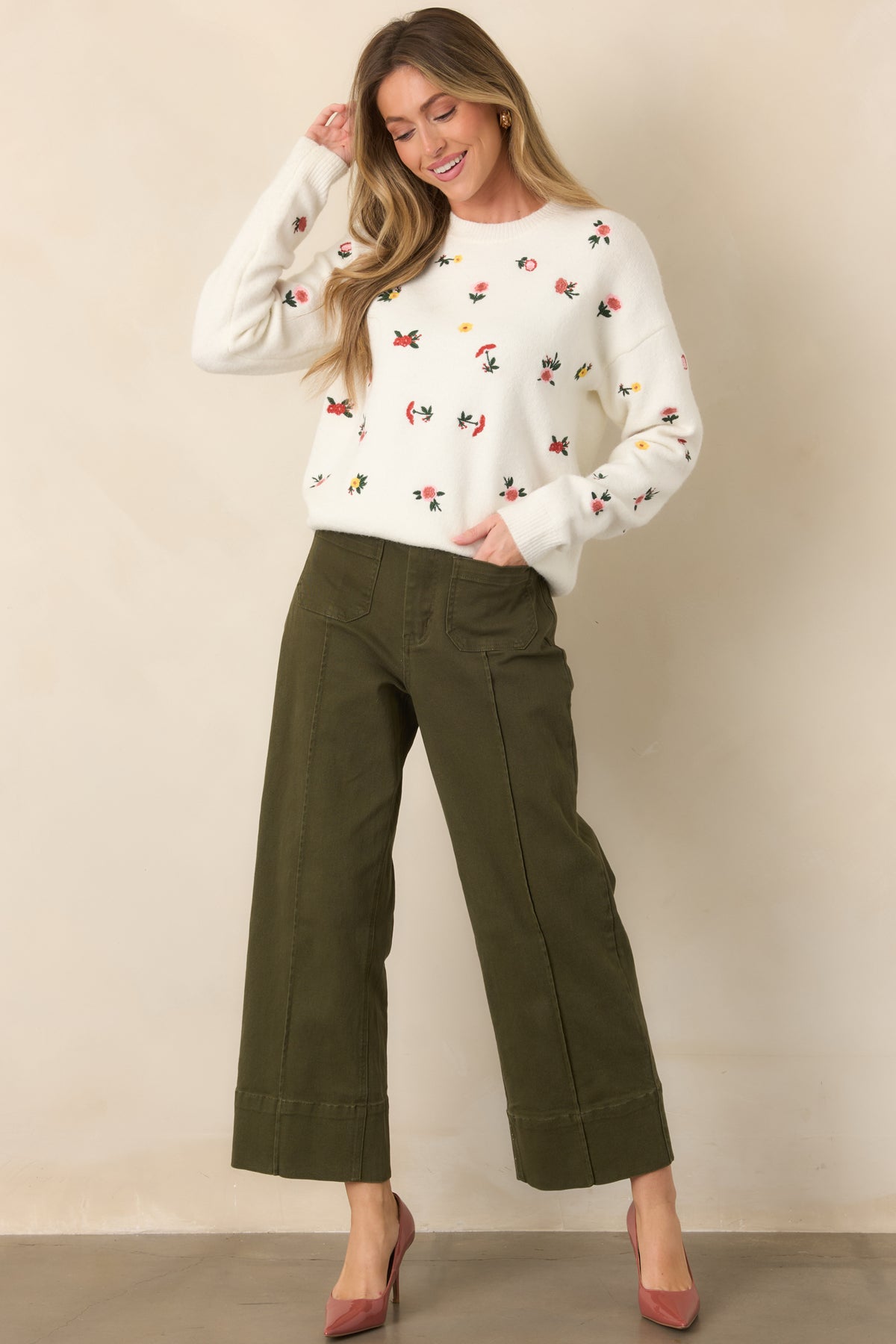 Polished olive pants showcasing a structured high-rise fit, wide cuff hems, belt loops, and modern utility-inspired pockets.