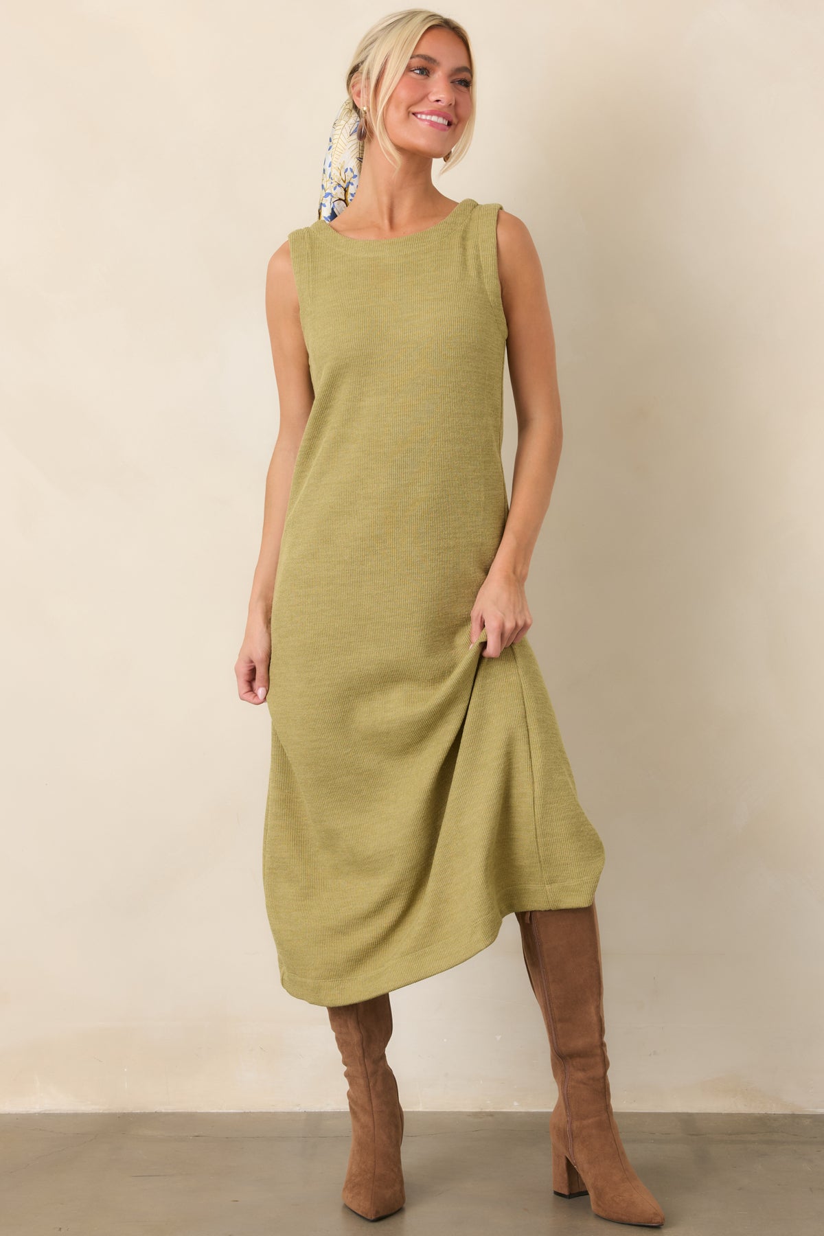 Olive green midi silhouette crafted from textured rib knit with a softly rounded neckline and clean finish.
