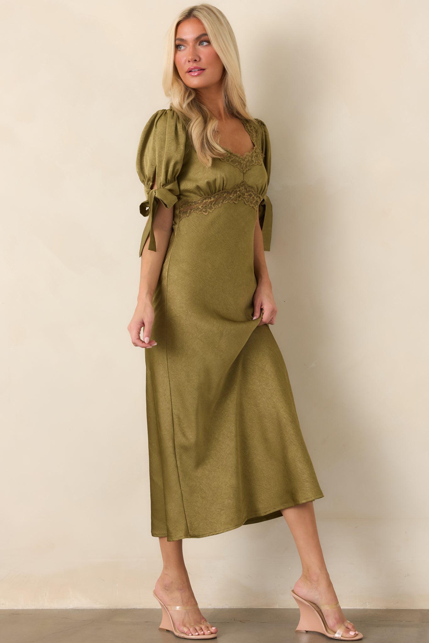 Polished satin midi dress showcasing a defined empire waist, lace-trimmed underbust seam, and graceful flowing skirt.