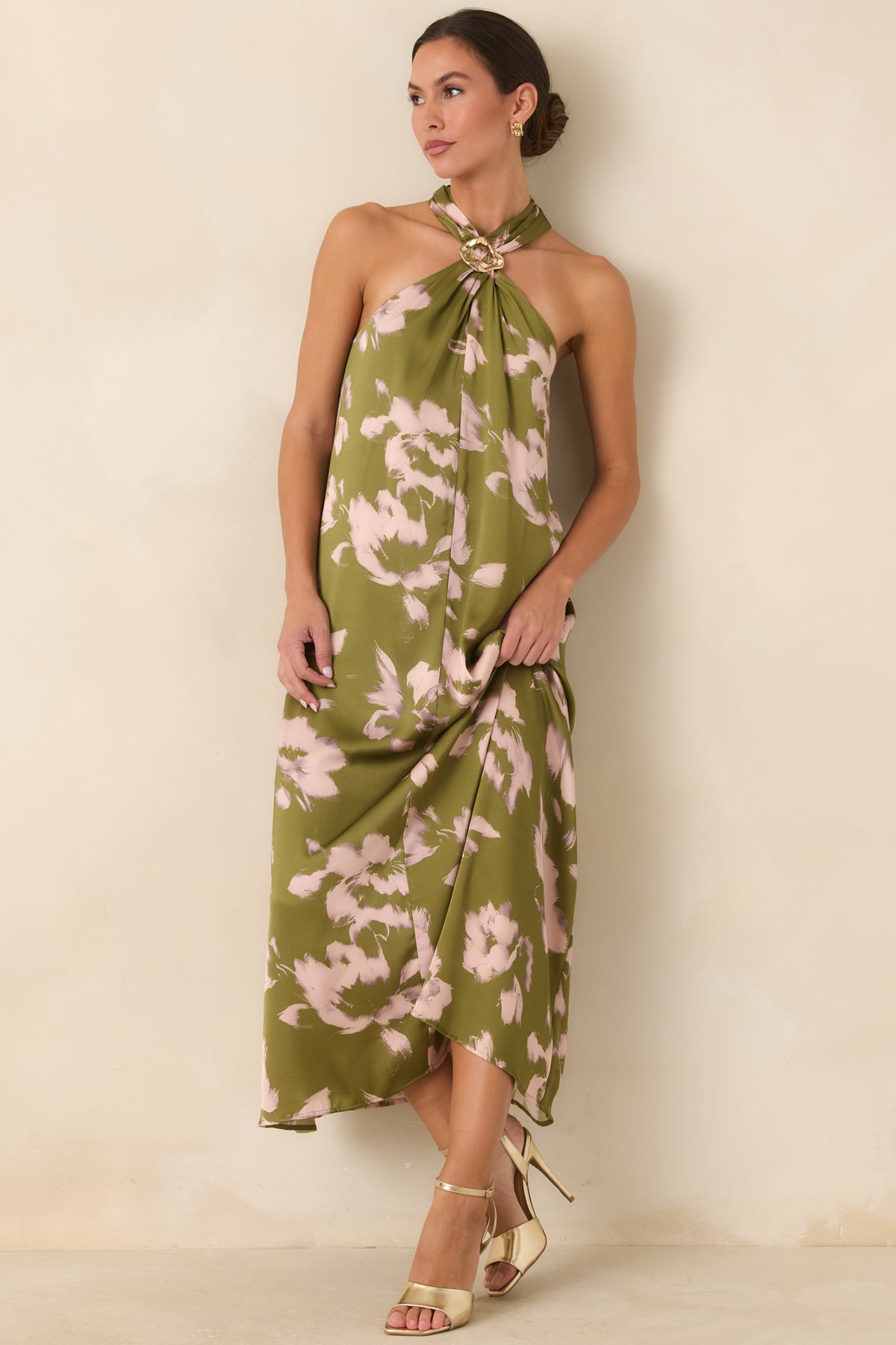 Sleeveless olive dress featuring an artistic blush floral print and graceful fabric that widens toward the hem.