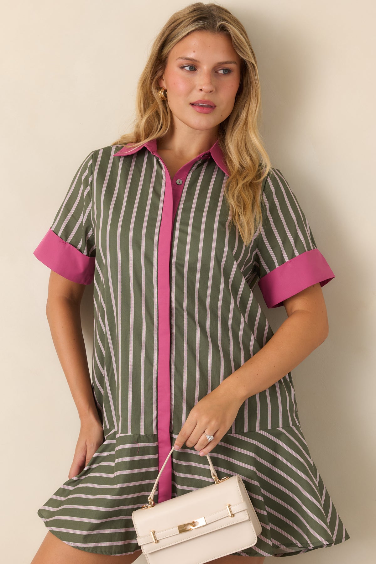 Olive striped dress showcasing the bold pink collar, front placket, and short sleeve cuffs.
