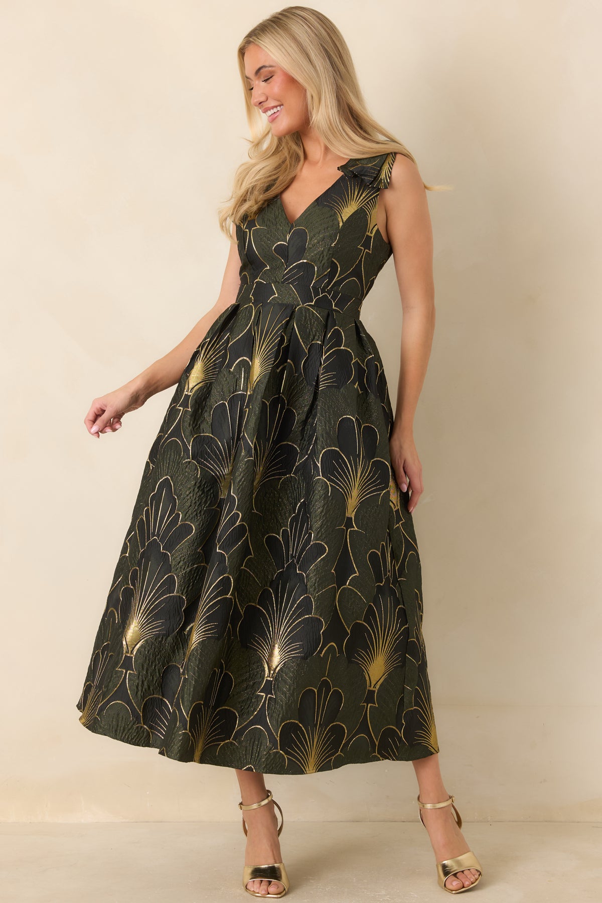 Rich olive dress with a V-neck bodice, ruffled shoulder straps, and a flowing midi skirt.