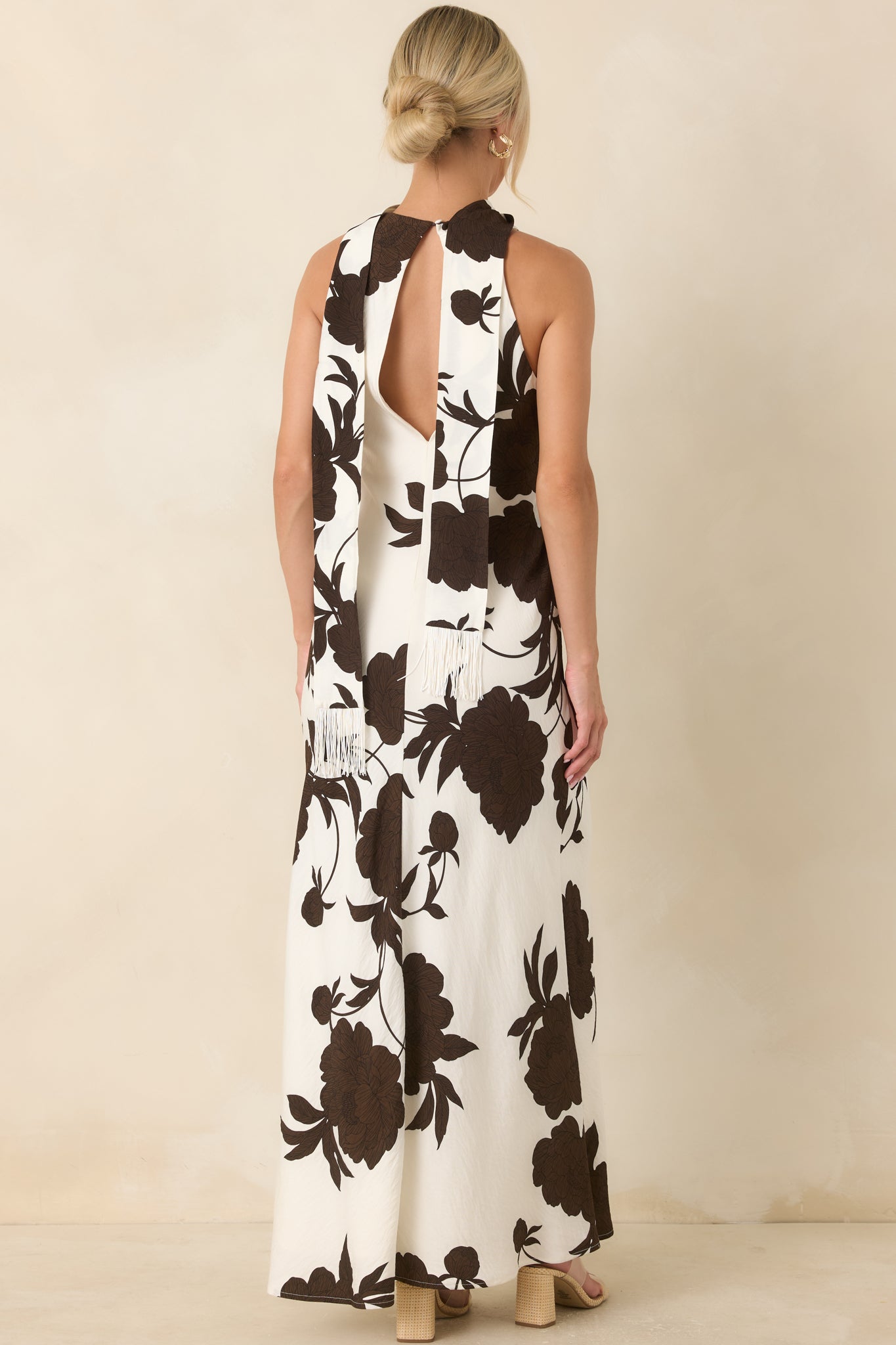 Back of the maxi dress featuring an open keyhole design with a single button closure.