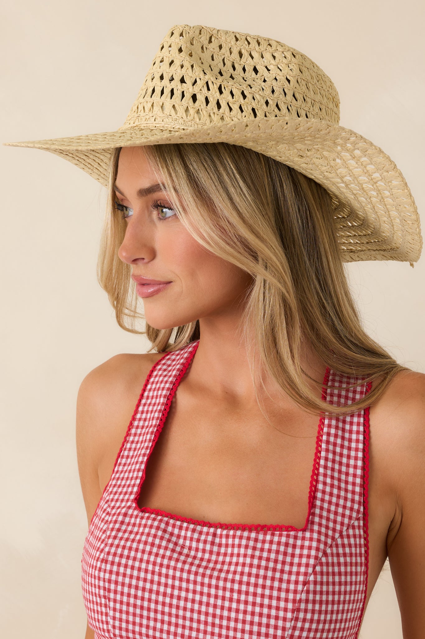 Open-weave ivory cowboy hat with a structured crown and soft textured straw construction.