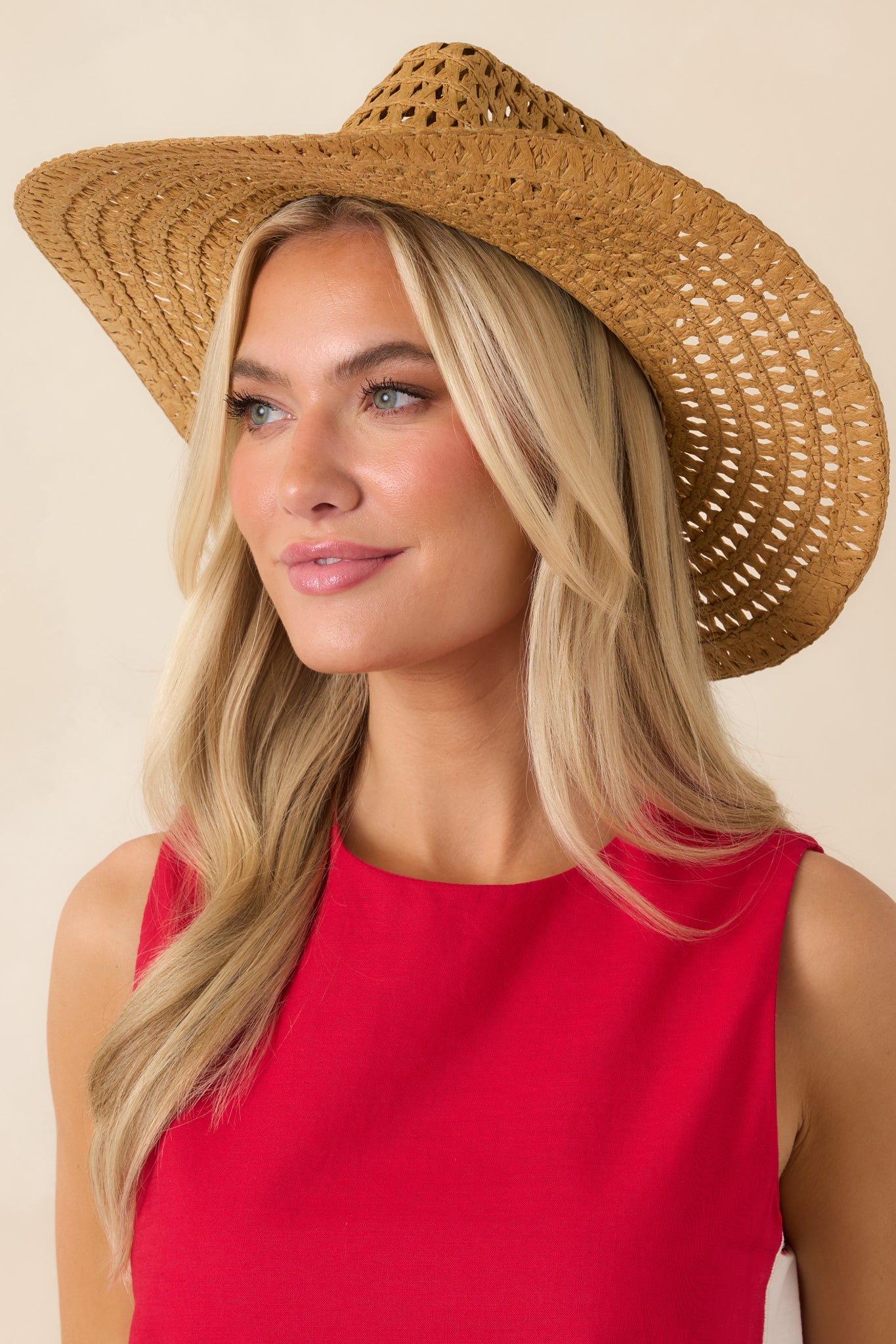 Open-weave straw cowboy hat featuring a structured crown, wide brim, and lightweight breathable texture