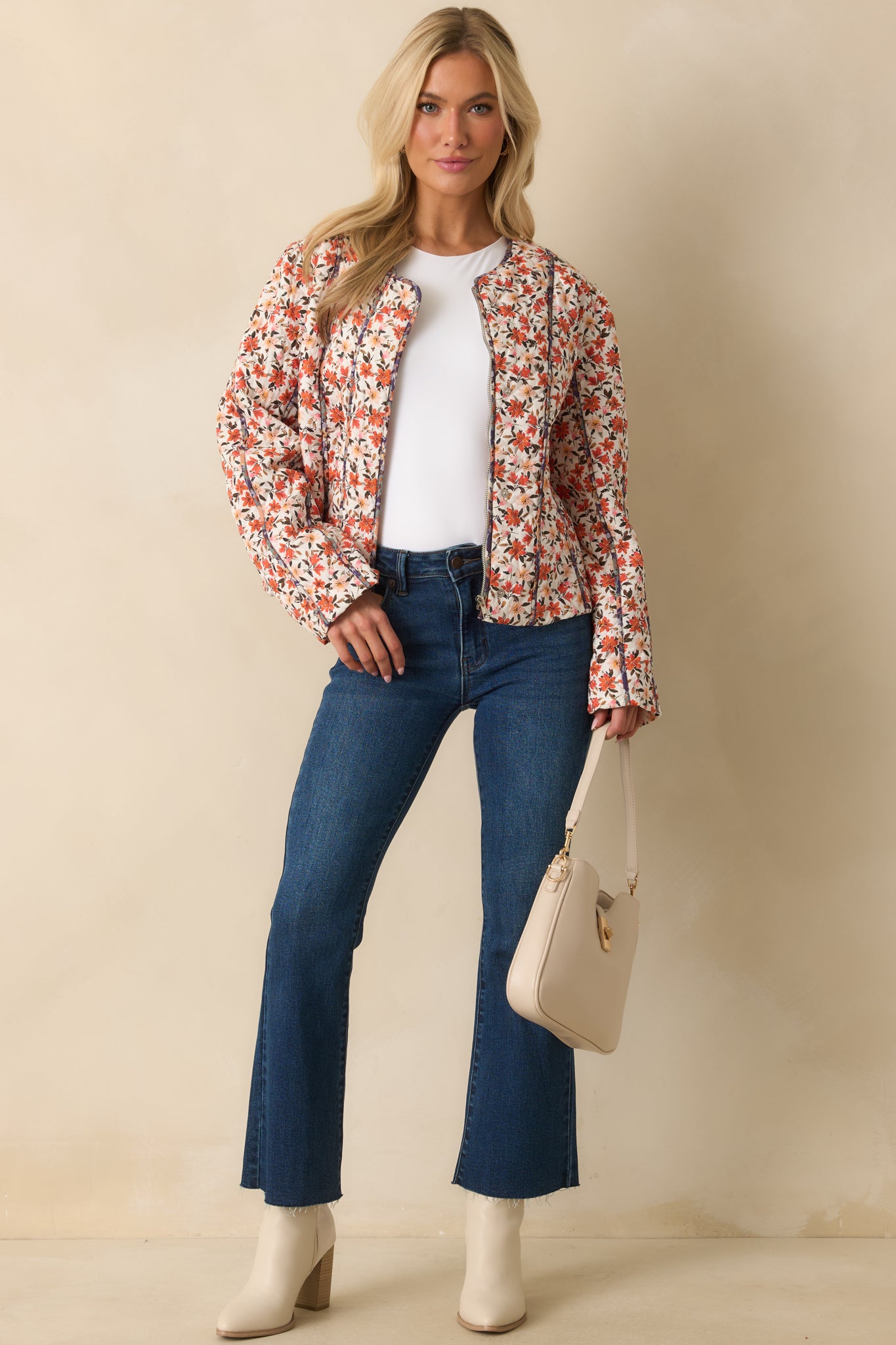 Vibrant orange floral jacket with vertical seam details and piping along the edges.