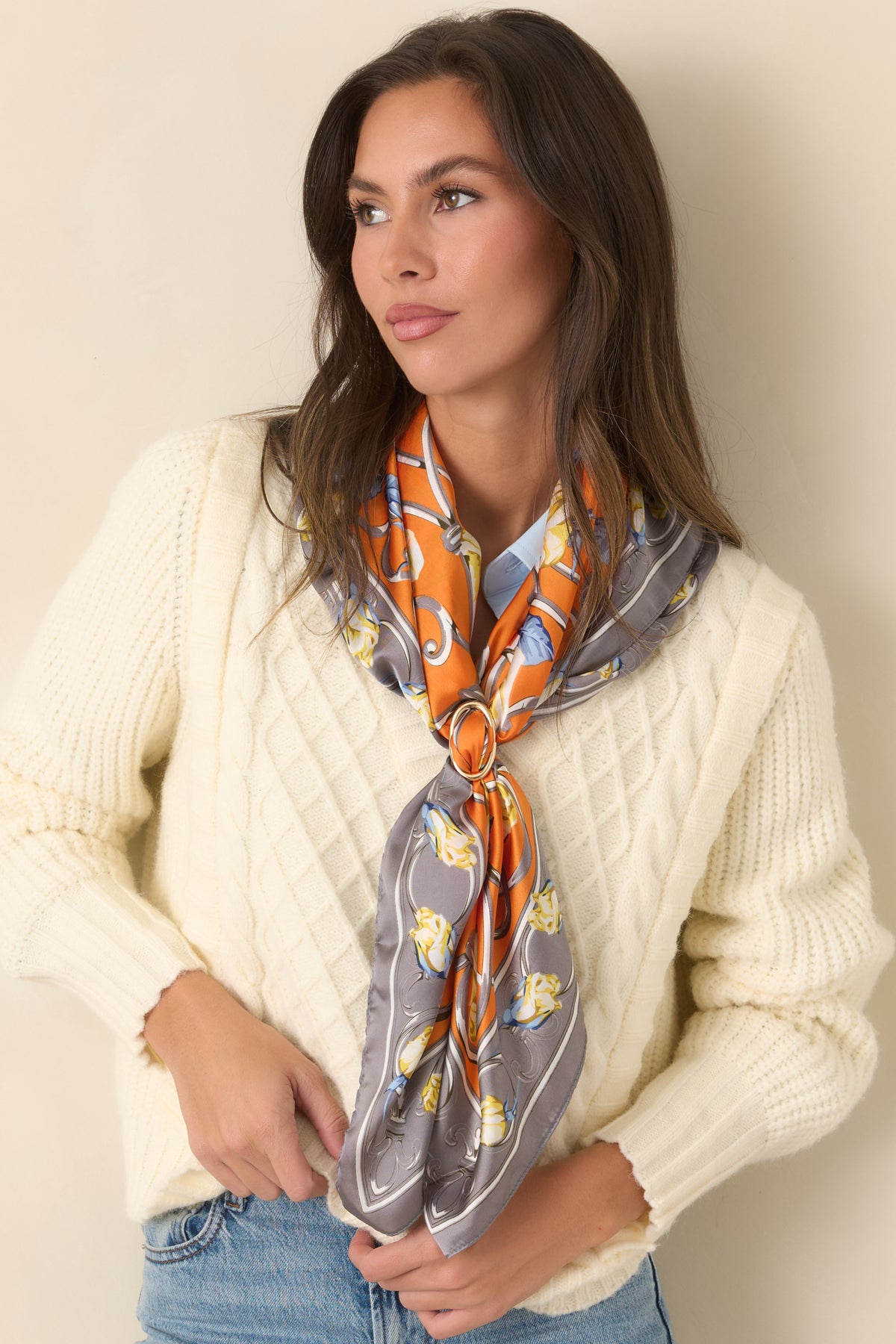 Vibrant orange scarf with climbing floral vines, pastel yellow roses, and a slate border decorated with intricate detailing.