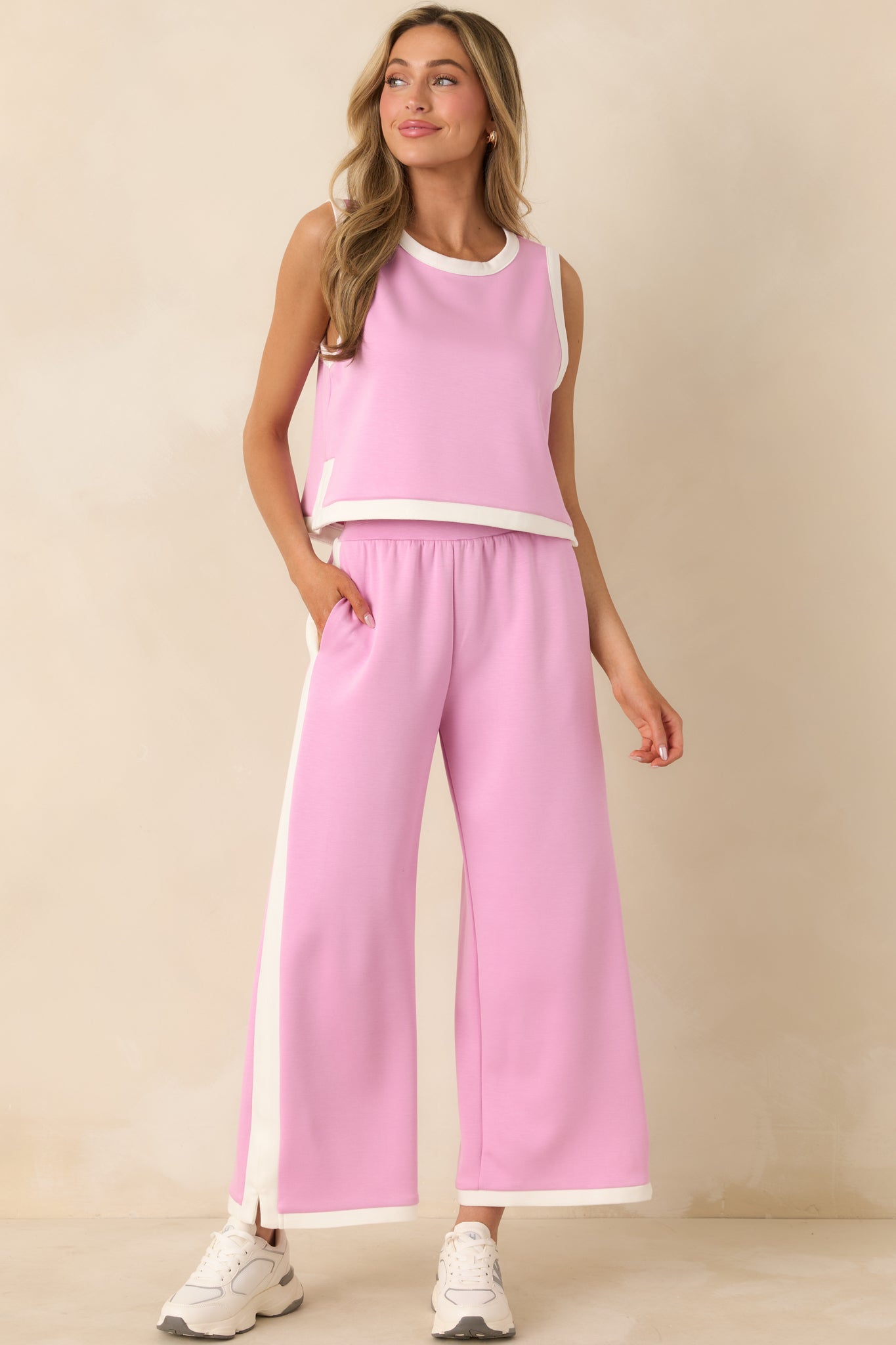 Orchid pink stretch knit pants with a relaxed wide-leg shape and sporty contrast side trim.