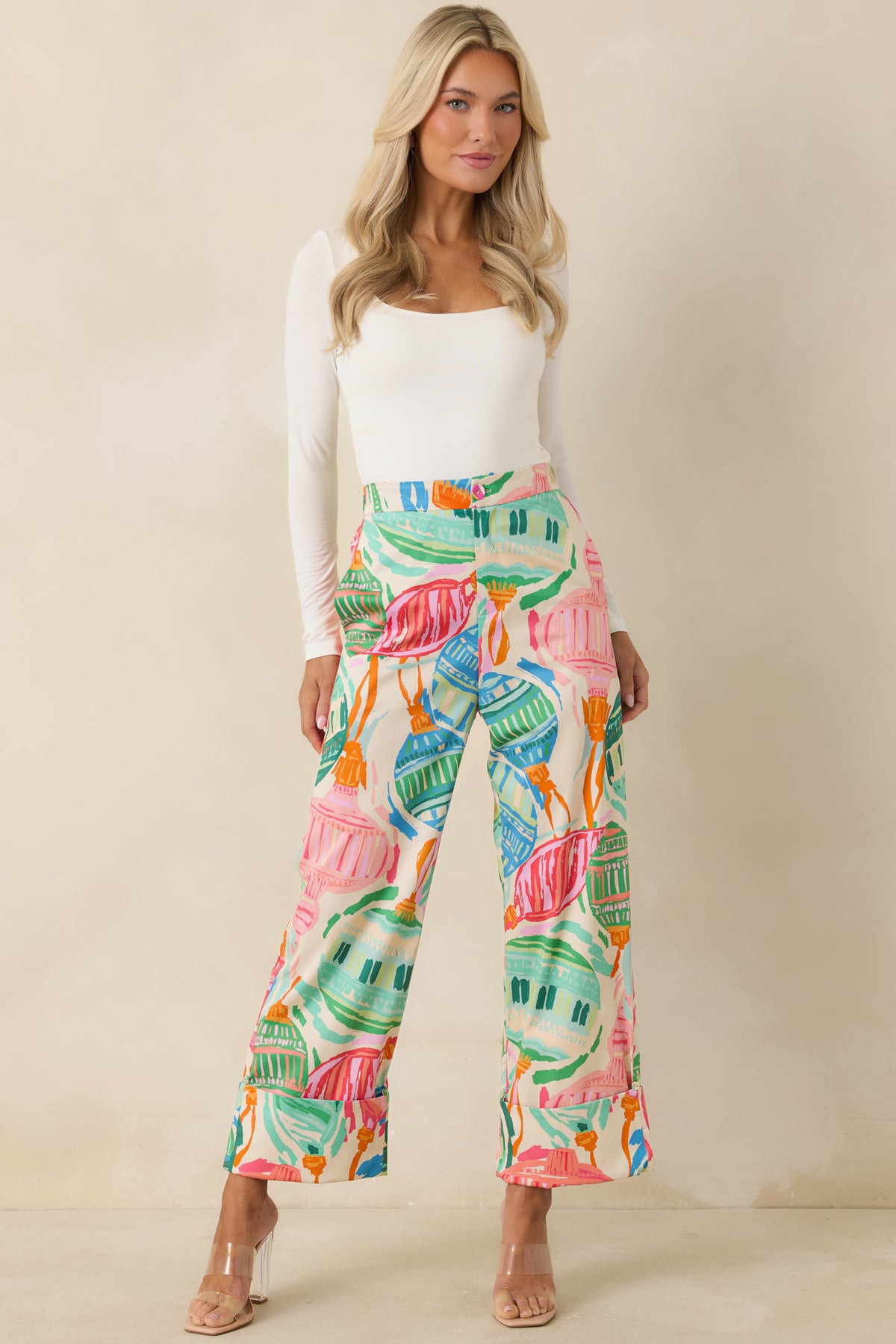 Colorful ornament-print pants with structured cuffed hems and a clean, tailored front.