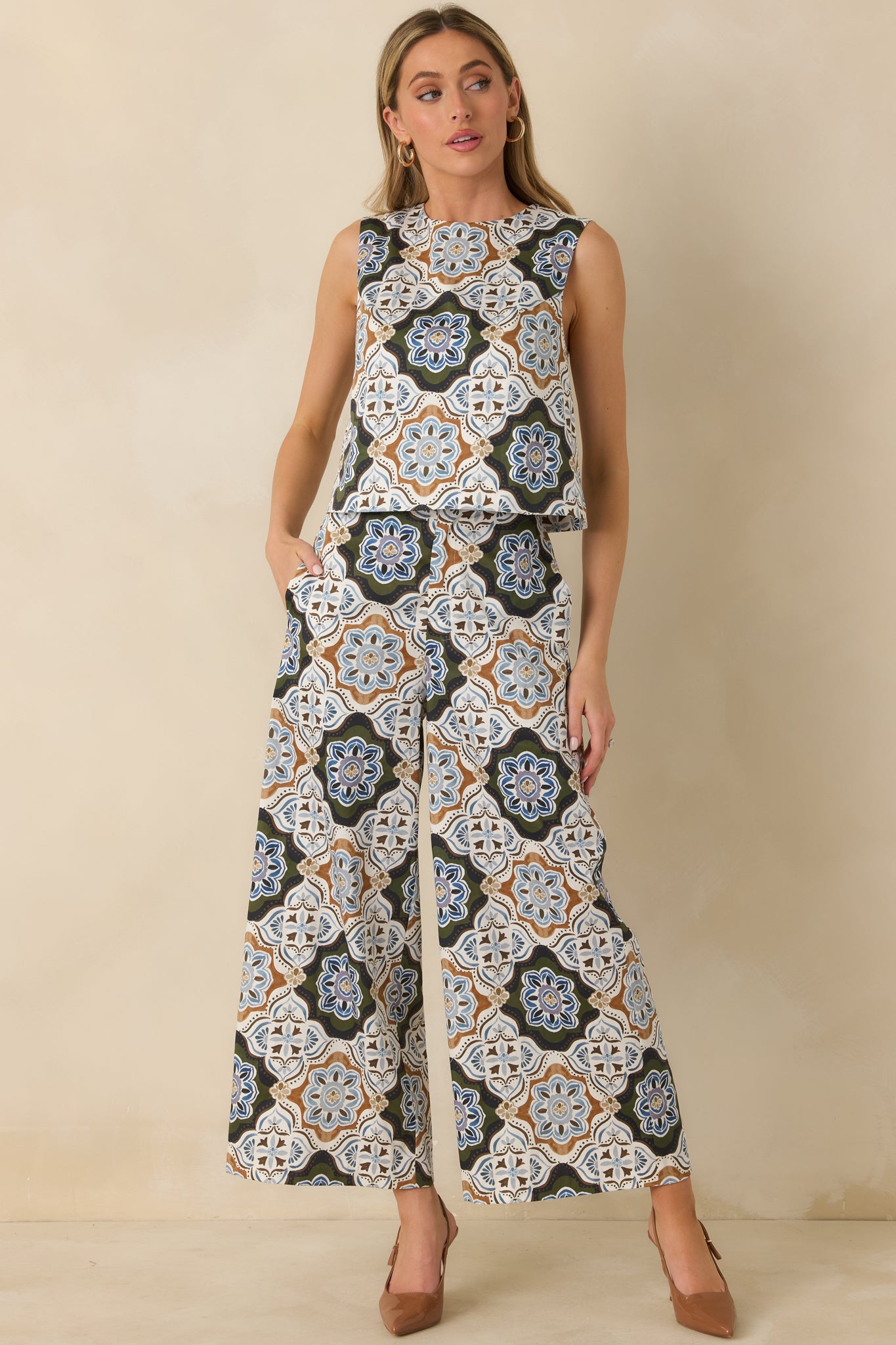 Ornate medallion print top designed with a classic round neckline and slightly cropped silhouette in olive green and multicolor tones.