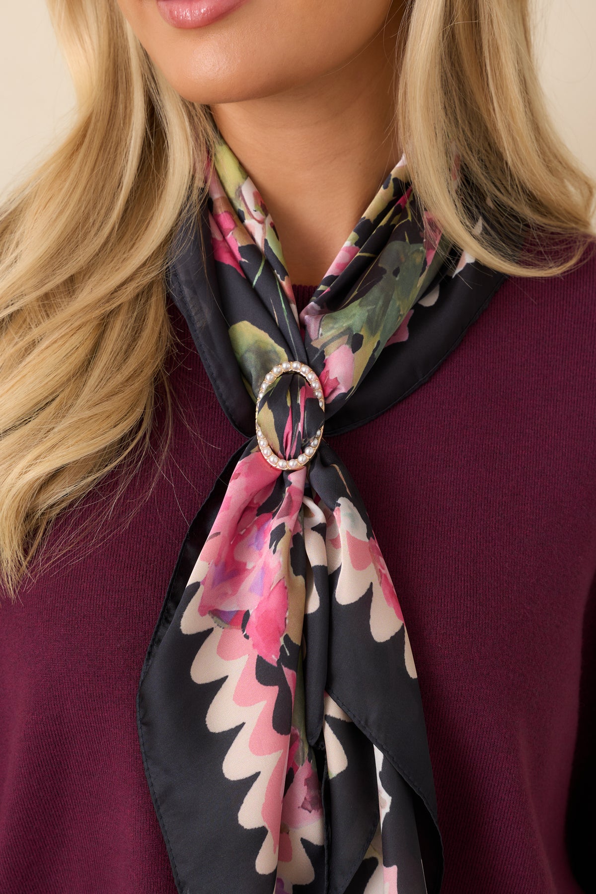 Oval gold-tone scarf ring features a row of lustrous pearl accents surrounding an open center for styling scarves.