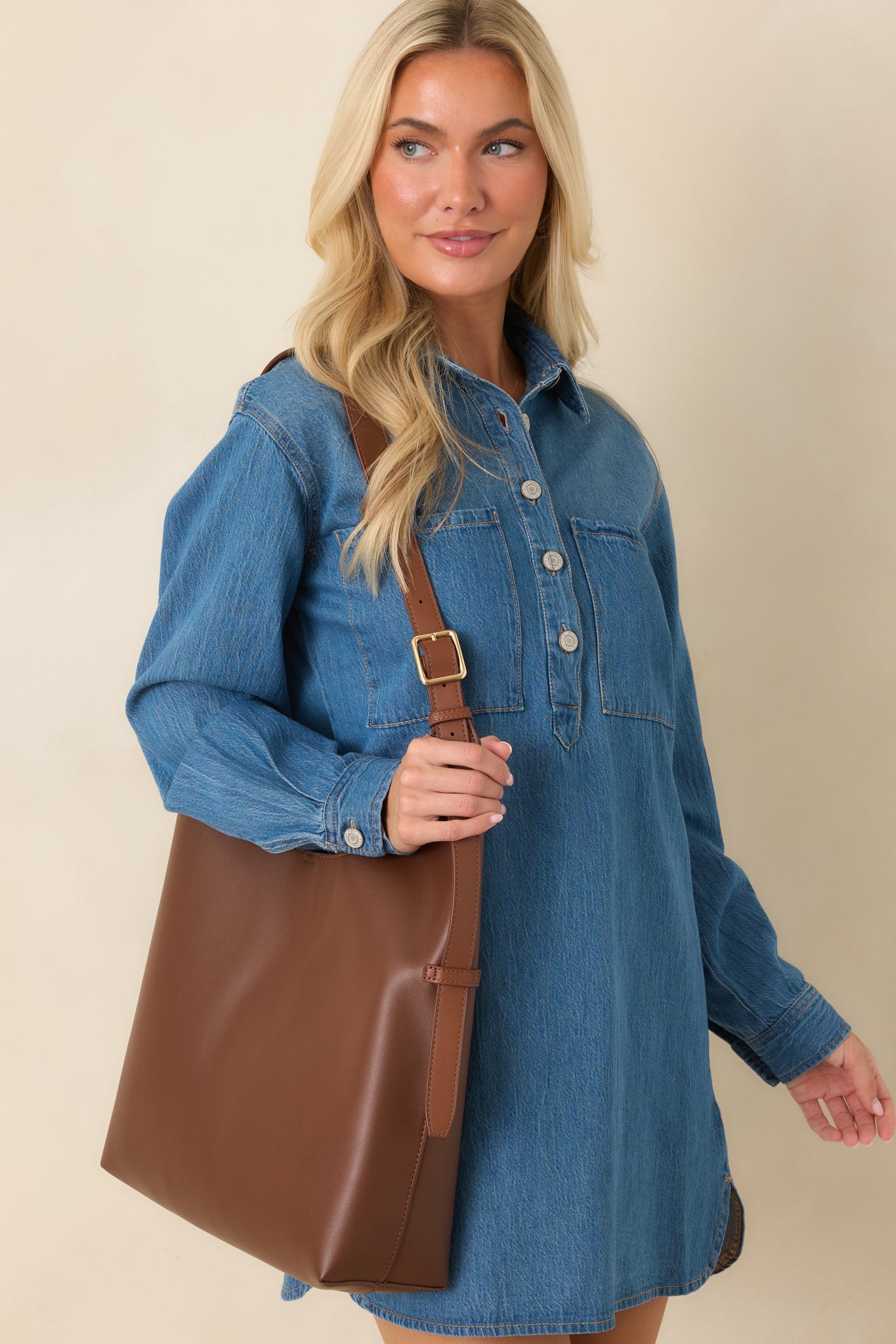 Close-up highlighting the oversized chest pockets and relaxed fabric construction of the dress.