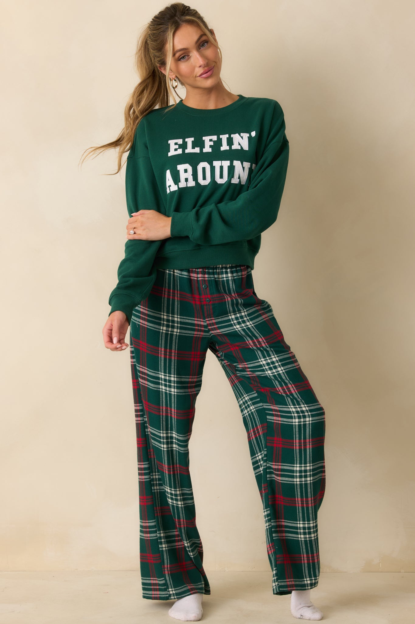 Oversized green sweatshirt with soft fleece fabric, a relaxed silhouette, and twill “Elfin’ Around” detailing across the chest.