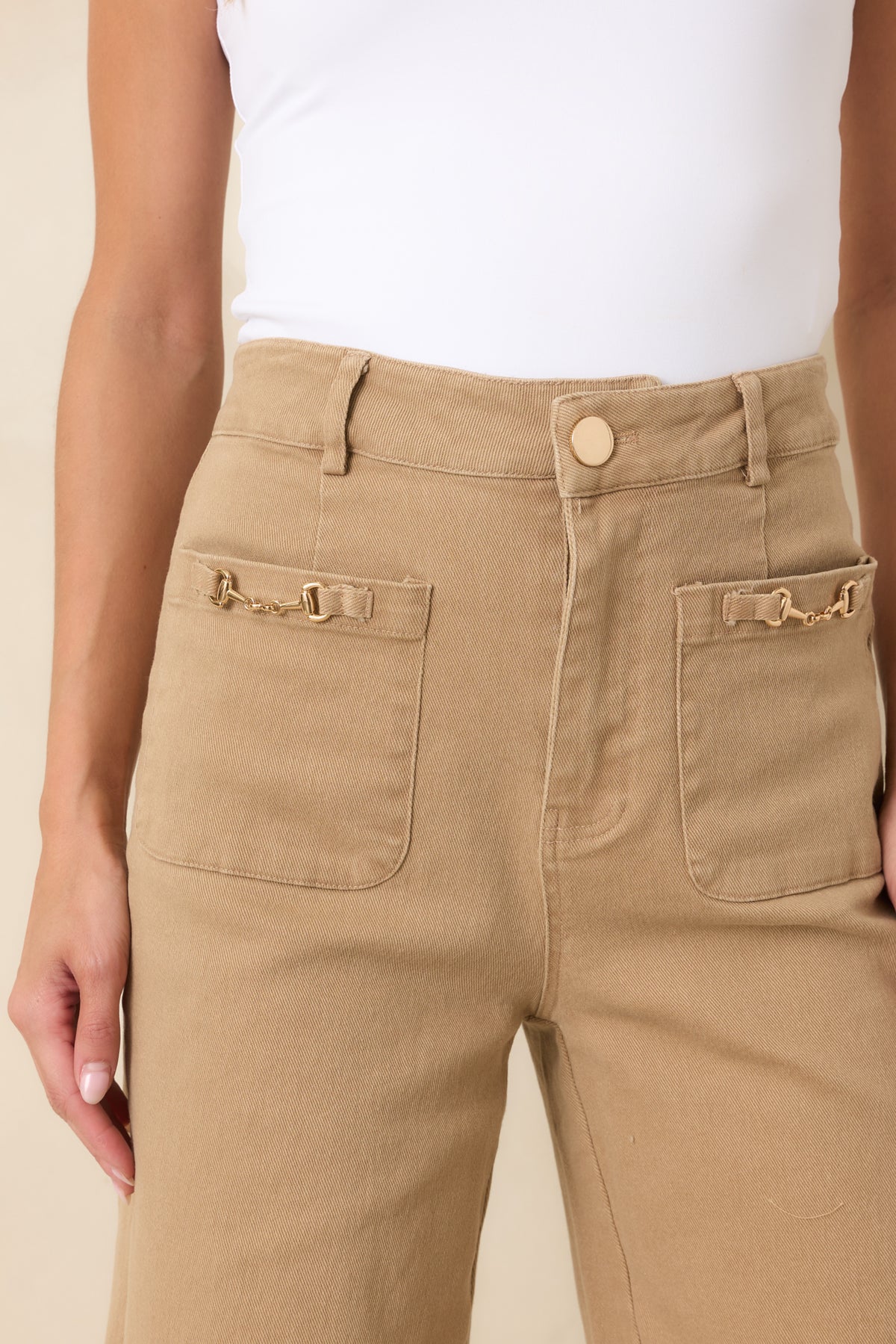 Close-up of the oversized front patch pocket accented with polished gold-tone horsebit hardware.