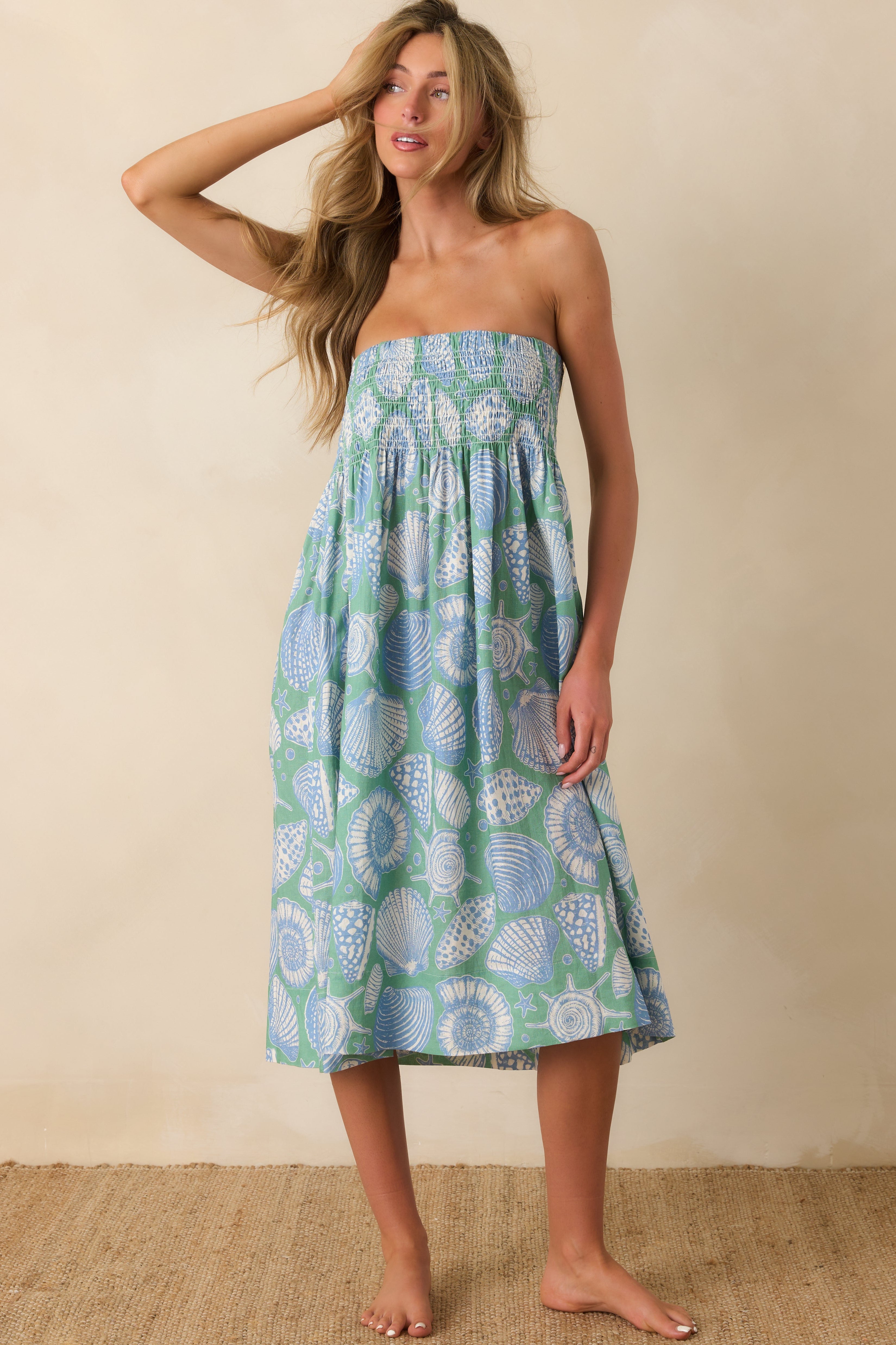 Complete shot of the midi dress showcasing its oversized coastal pattern with soft blue and ivory colors.