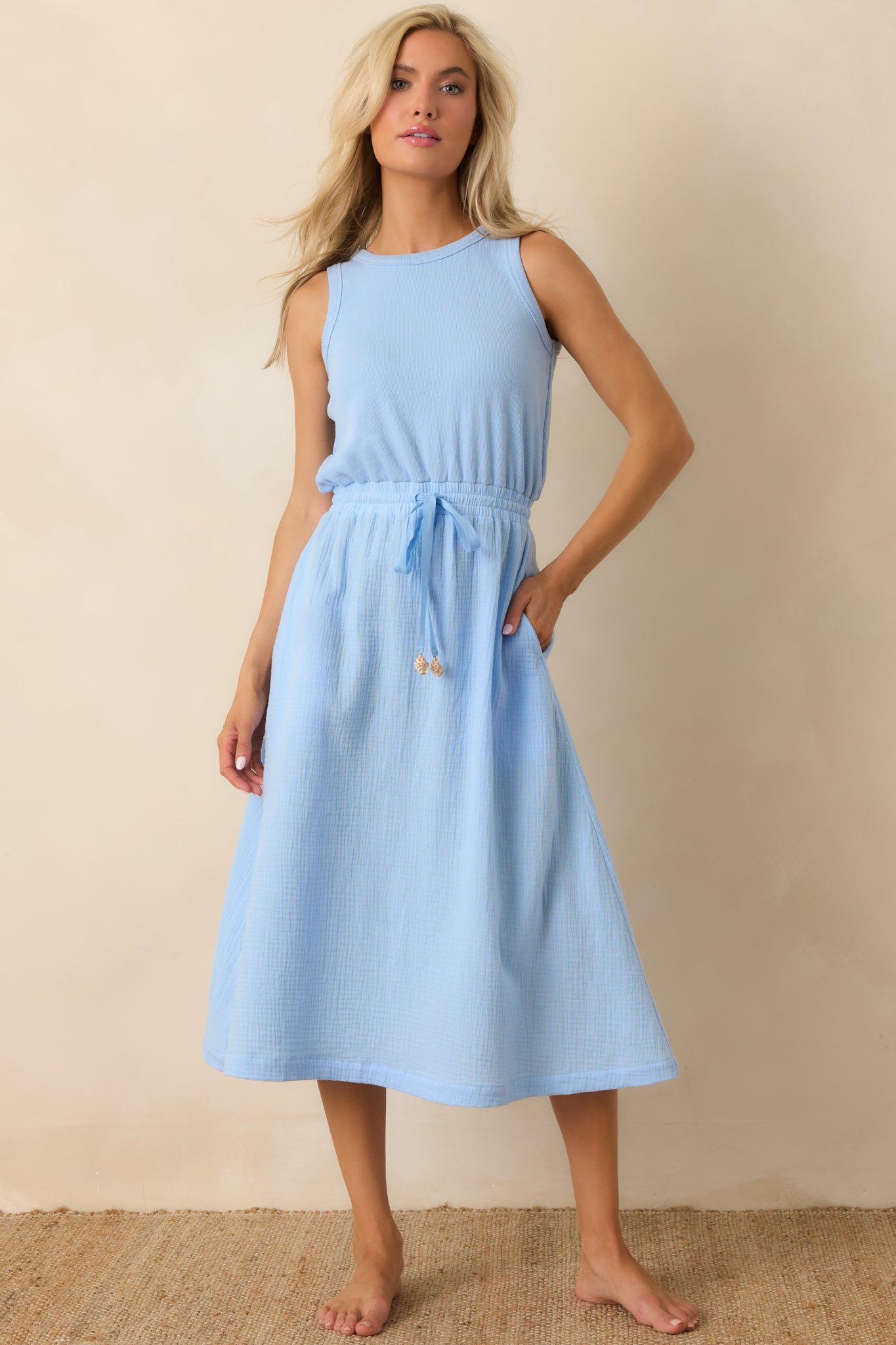 Breathable cotton midi dress with subtle texture, elasticized waist, and softly flowing skirt.