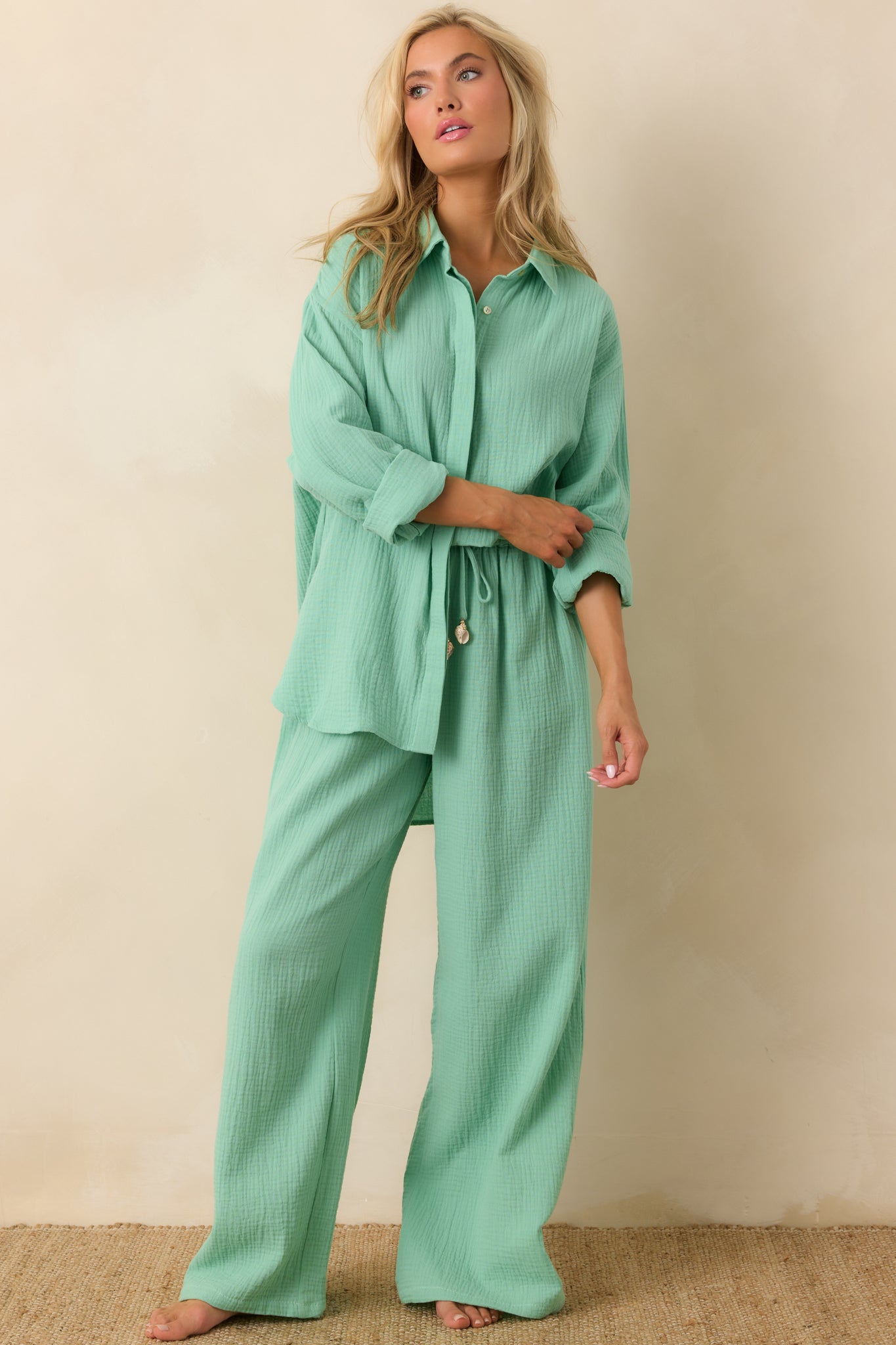 Lightweight cotton shirt in soft green with full front buttons and airy, textured fabric.