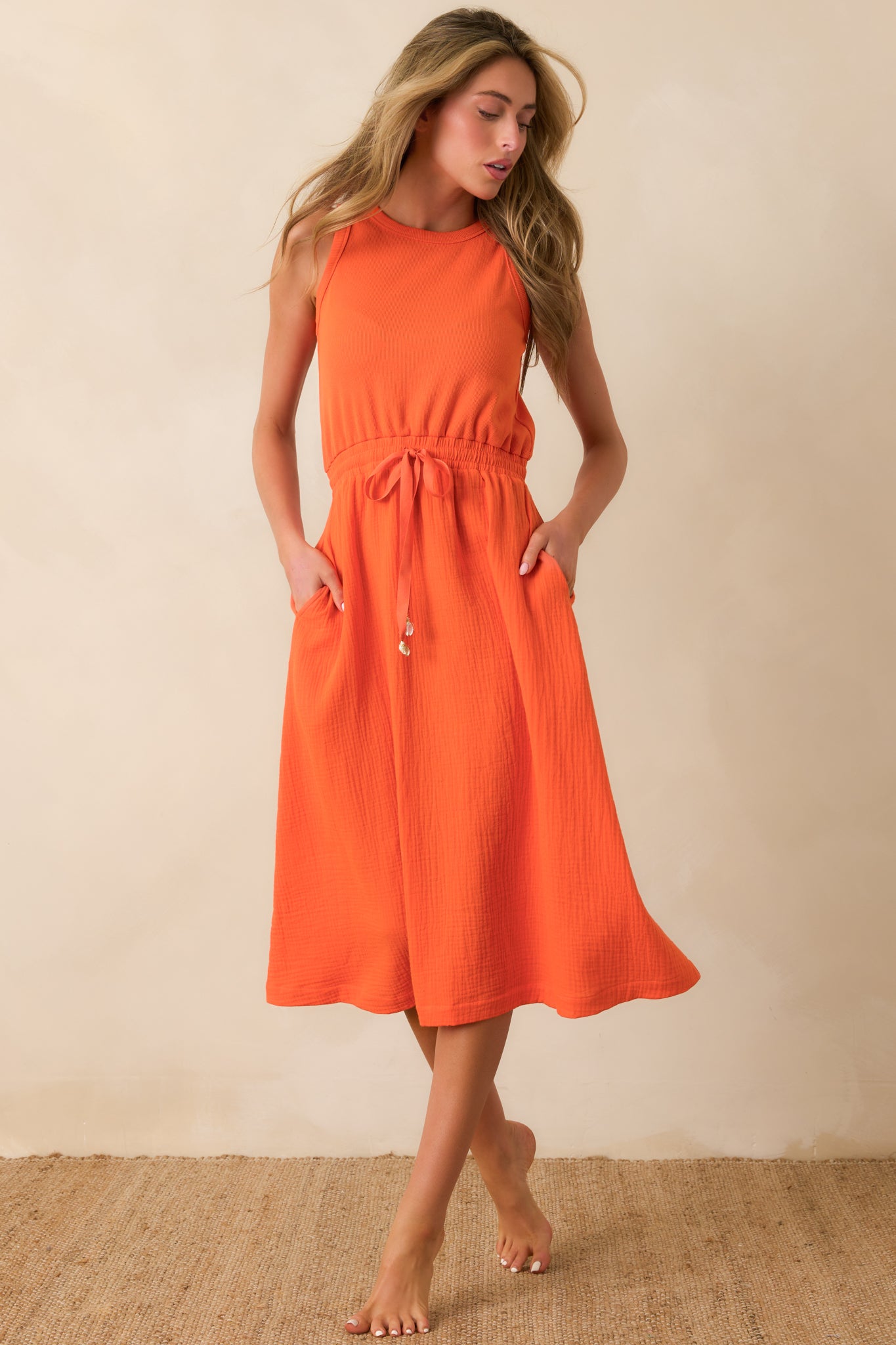 Lightweight textured cotton midi dress with sleeveless silhouette, round neckline, and adjustable drawstring waist.