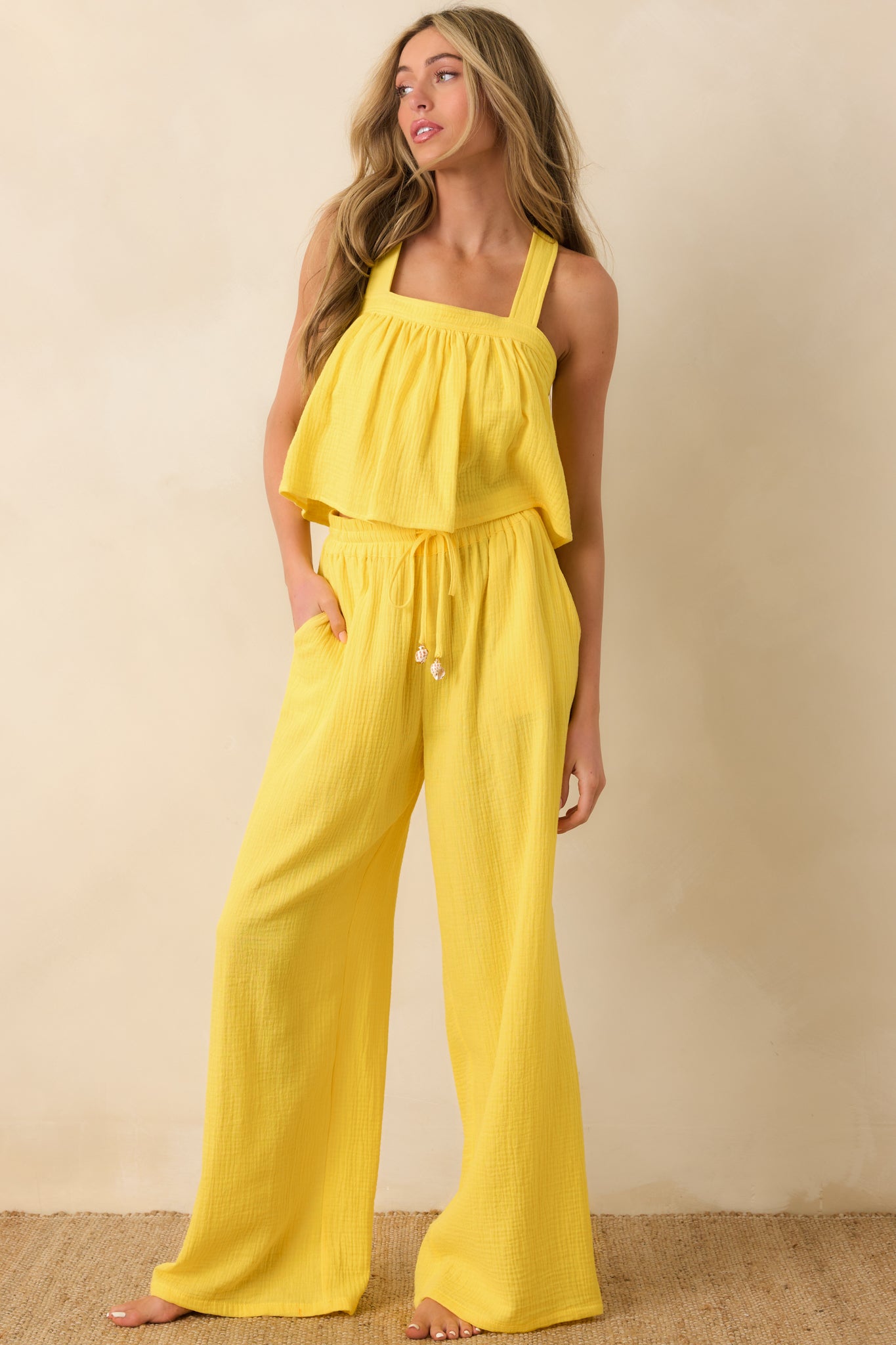 Lightweight yellow pants with elastic waistband and flowing wide-leg shape.
