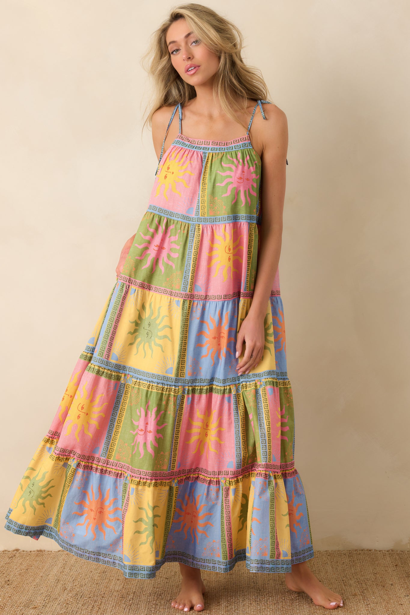 Sun-inspired print maxi dress with a relaxed fit, tiered skirt structure, and delicate tie straps framing the neckline.