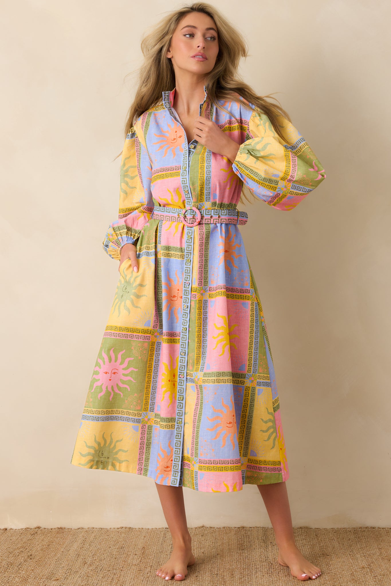Colorful patchwork midi dress highlighting a classic collared structure balanced by a cinched waist and soft, feminine sleeve detail.